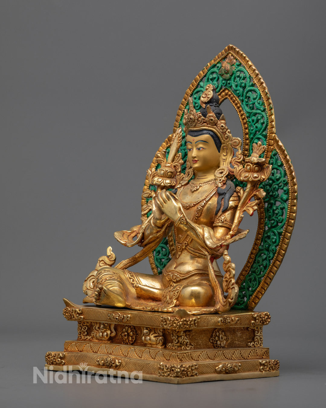 Manjushri statue with hollow chamber for mantras, featuring vibrant acrylic colors and ornate crown