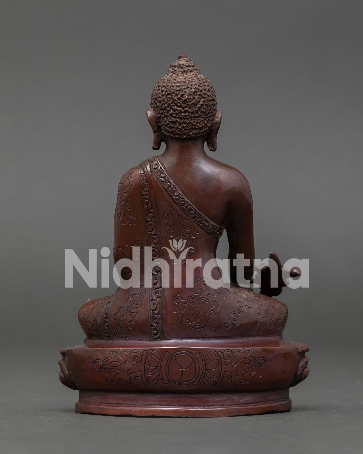 Medicine Buddha back view seated on lotus pedestal handcrafted copper statue from Nepal.