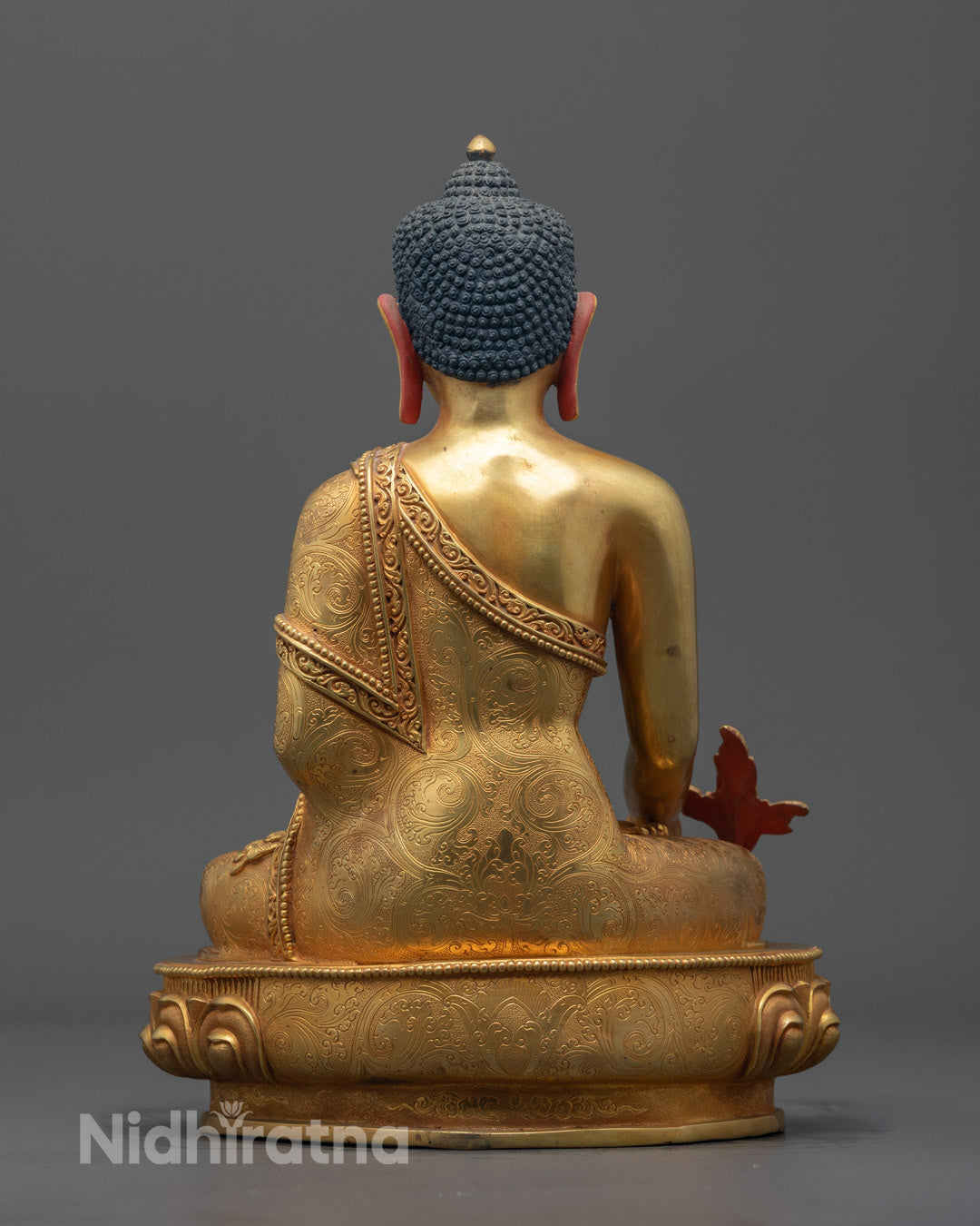 Back view of Medicine Buddha statue featuring detailed carvings