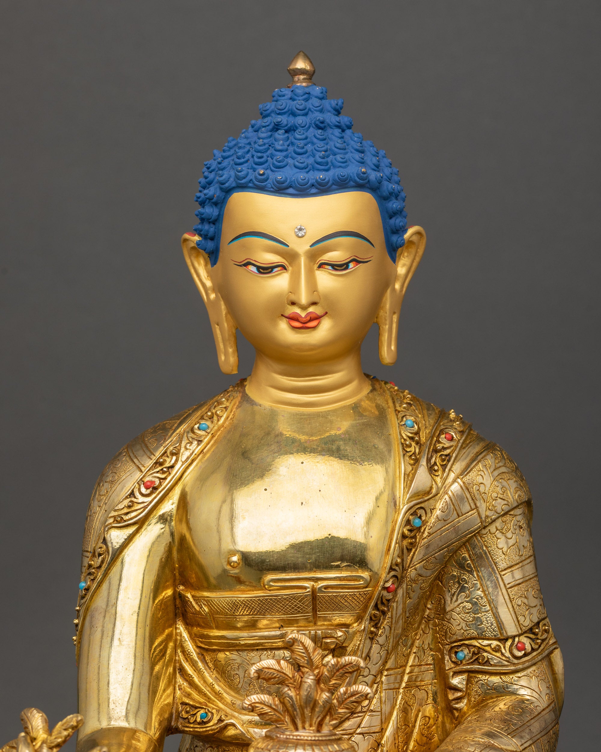 Medicine Buddha statue close up showing lotus seat and serene posture