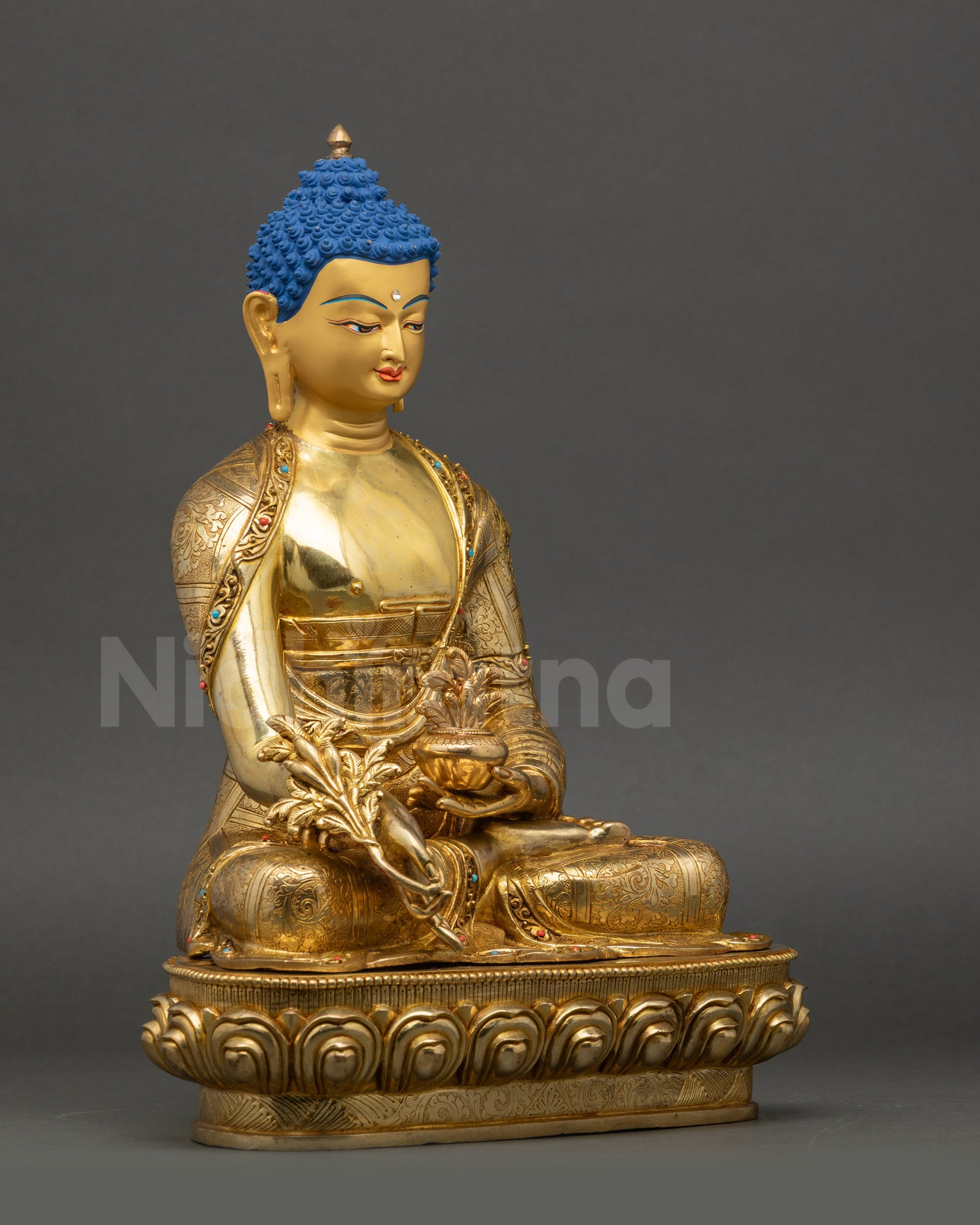 Medicine Buddha statue right side view with intricate garments and lotus seat