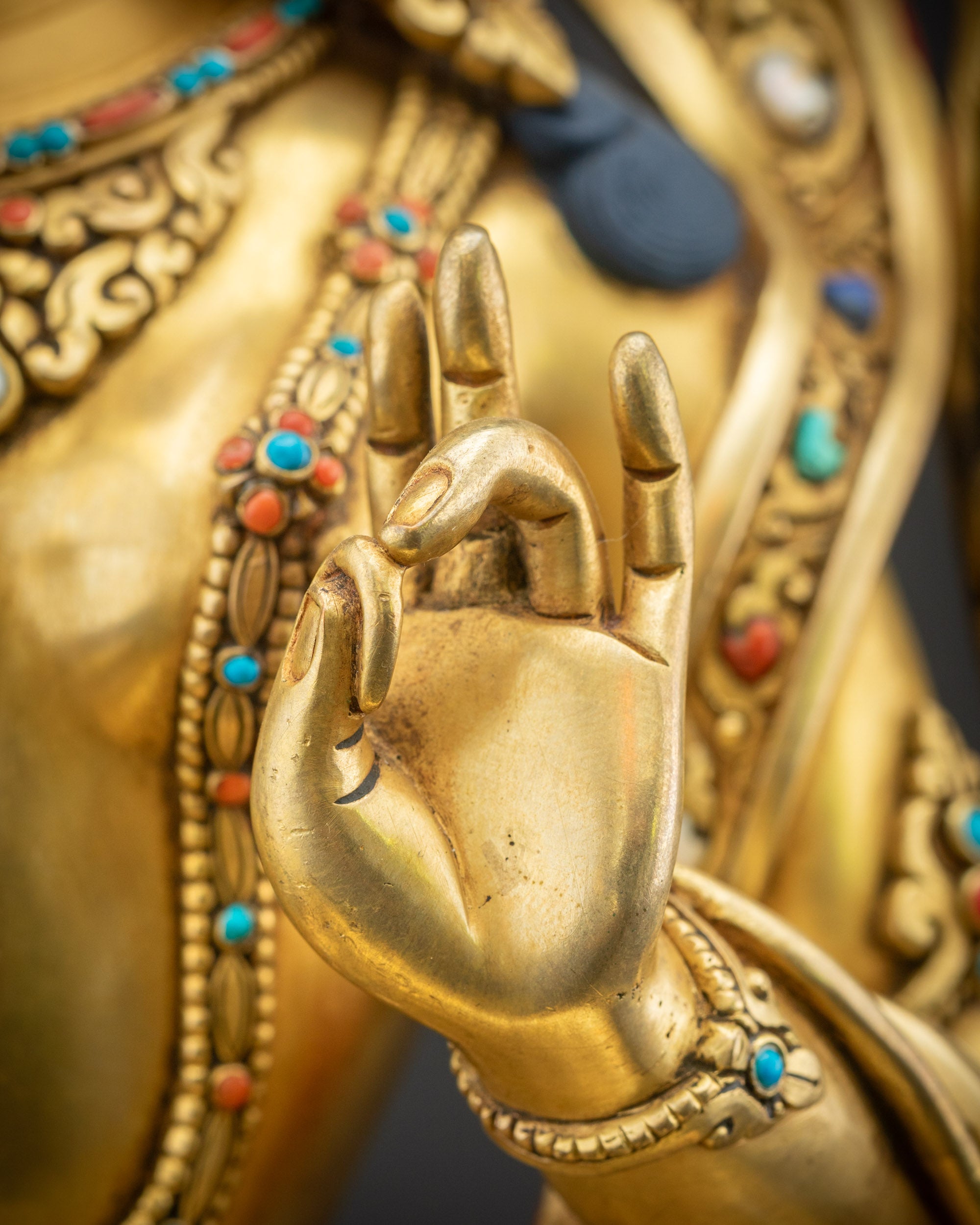Mudra close up showing Abhaya and Varada hand gestures with gold highlights