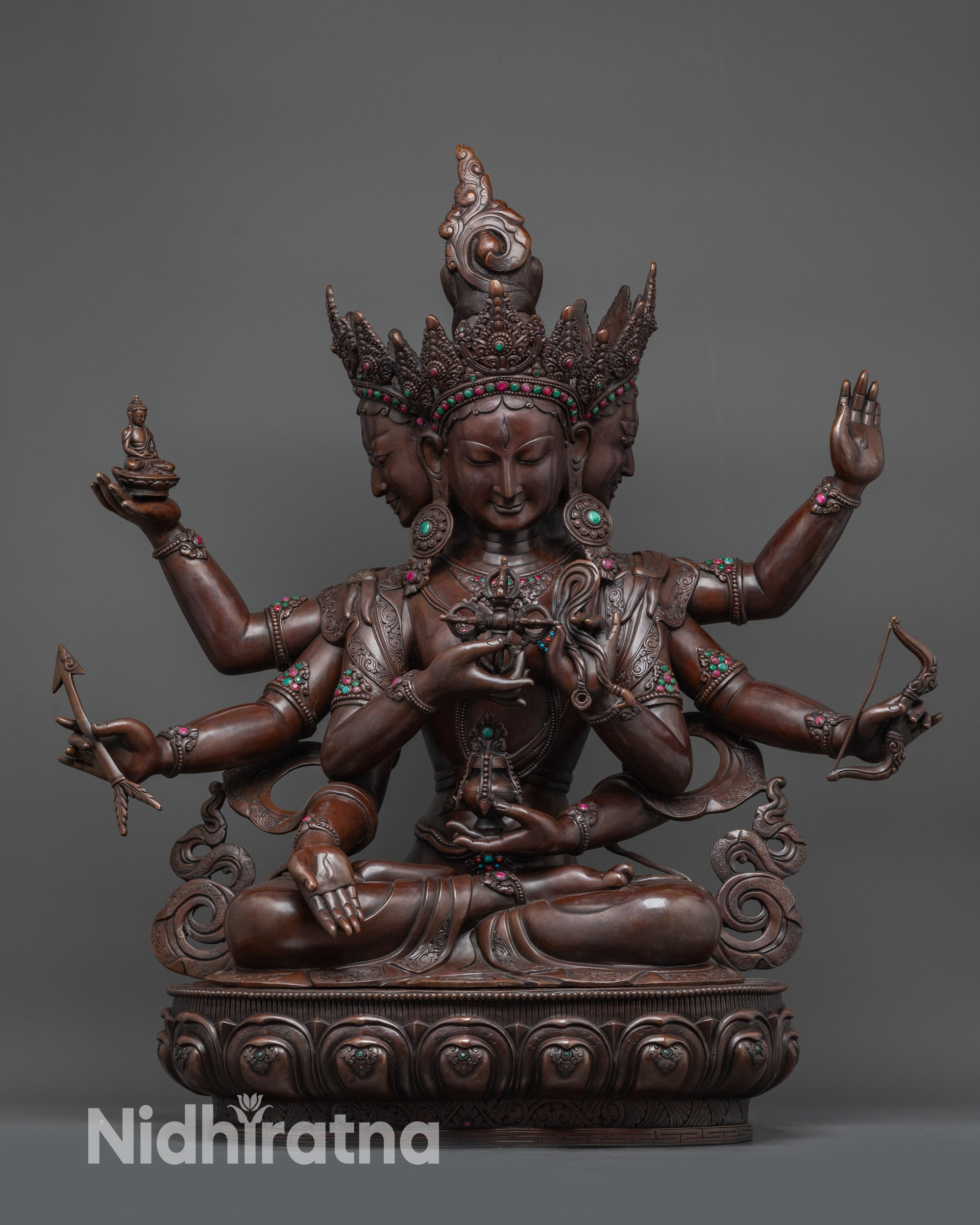 Oxidized Namgyalma statue front view with three faces and eight arms on lotus seat