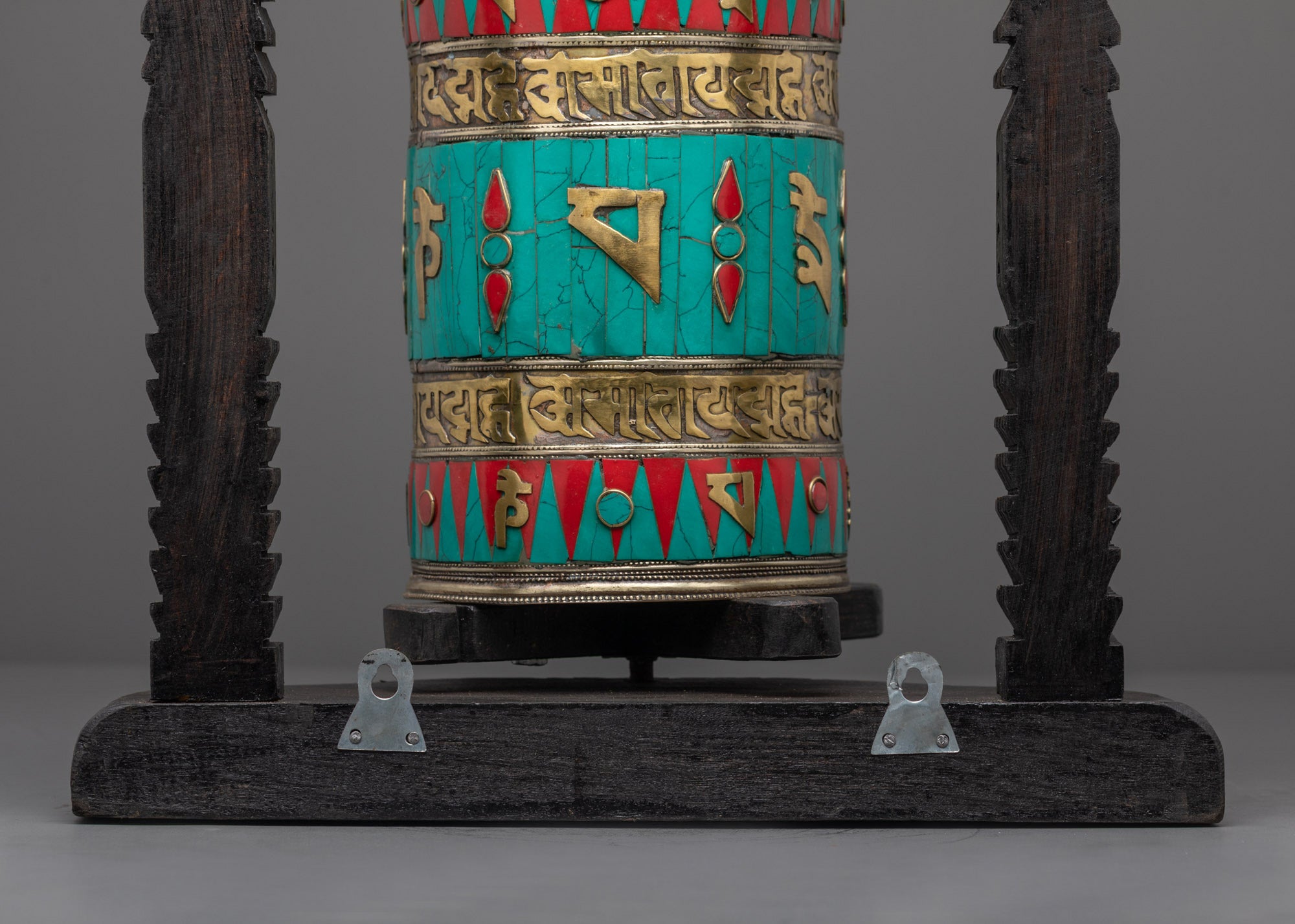 Prayer Wheel spinning on dark wooden base, perfect for meditation and blessing rituals