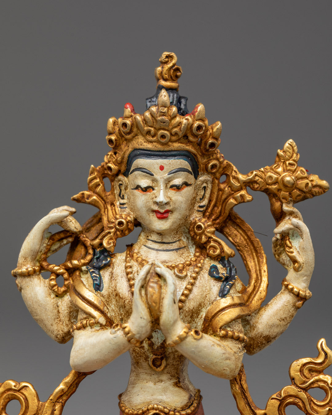 Premium machine-made Avalokitesvara statue with acrylic-painted details, vibrant orange lower garment, and wish-fulfilling gem in both hands.