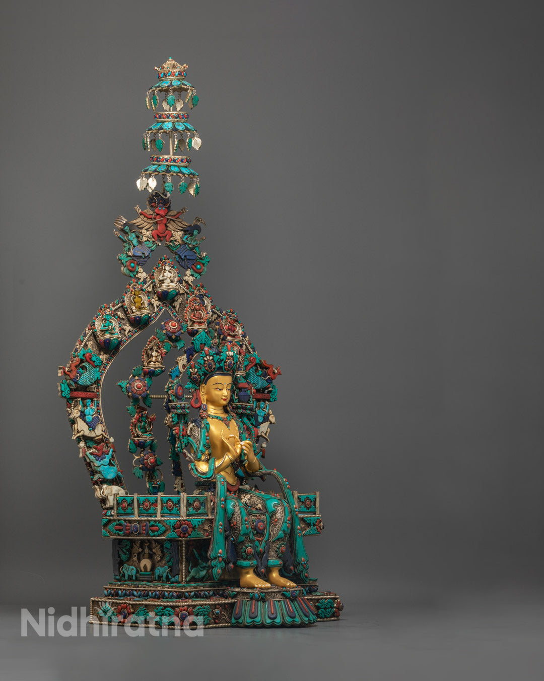 Maitreya Buddha statue showcasing intricate copper throne with lapis lazuli and coral stone decorations