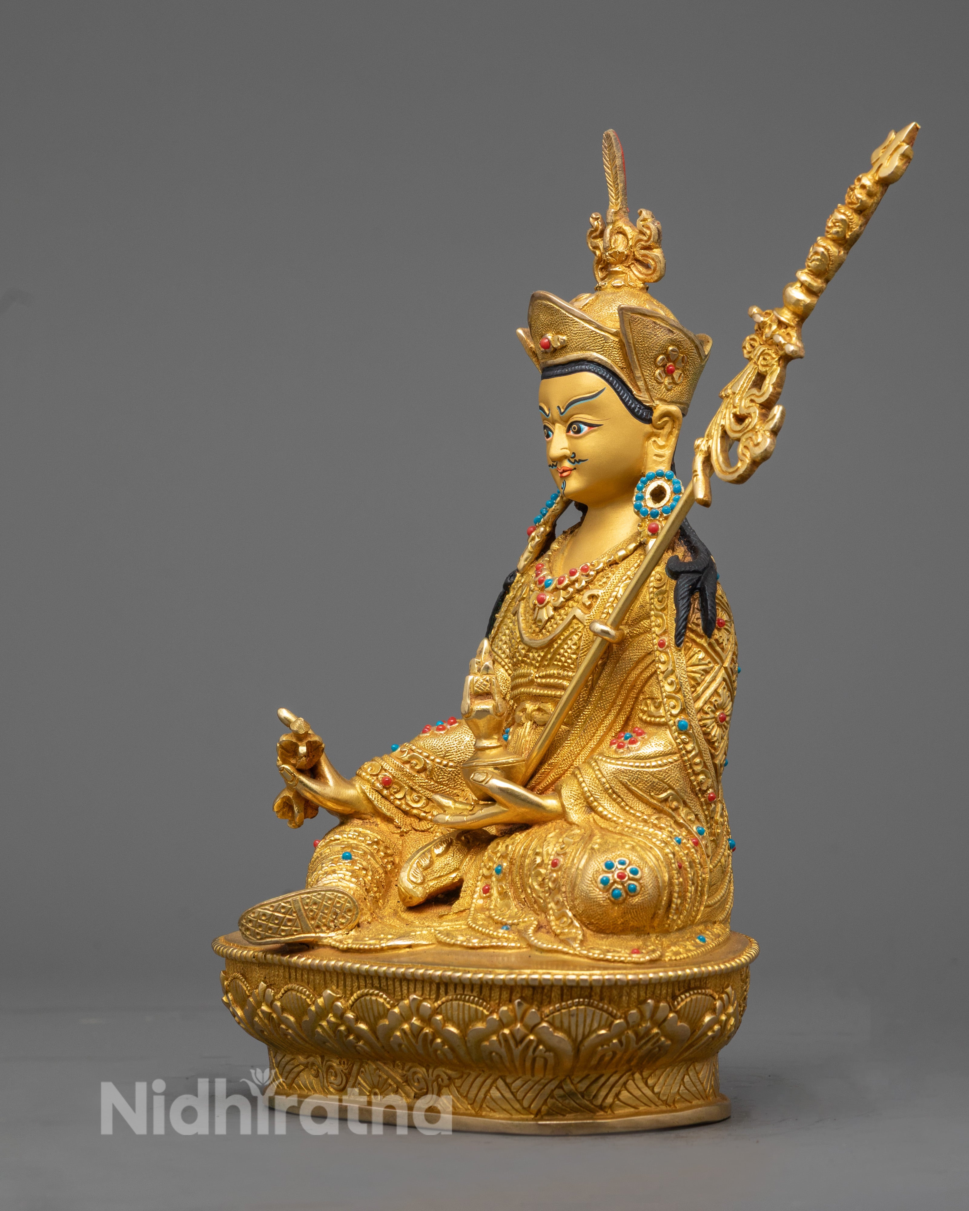 Guru Rinpoche Statue Highlighting Intricate Robe Patterns and Trident Symbol