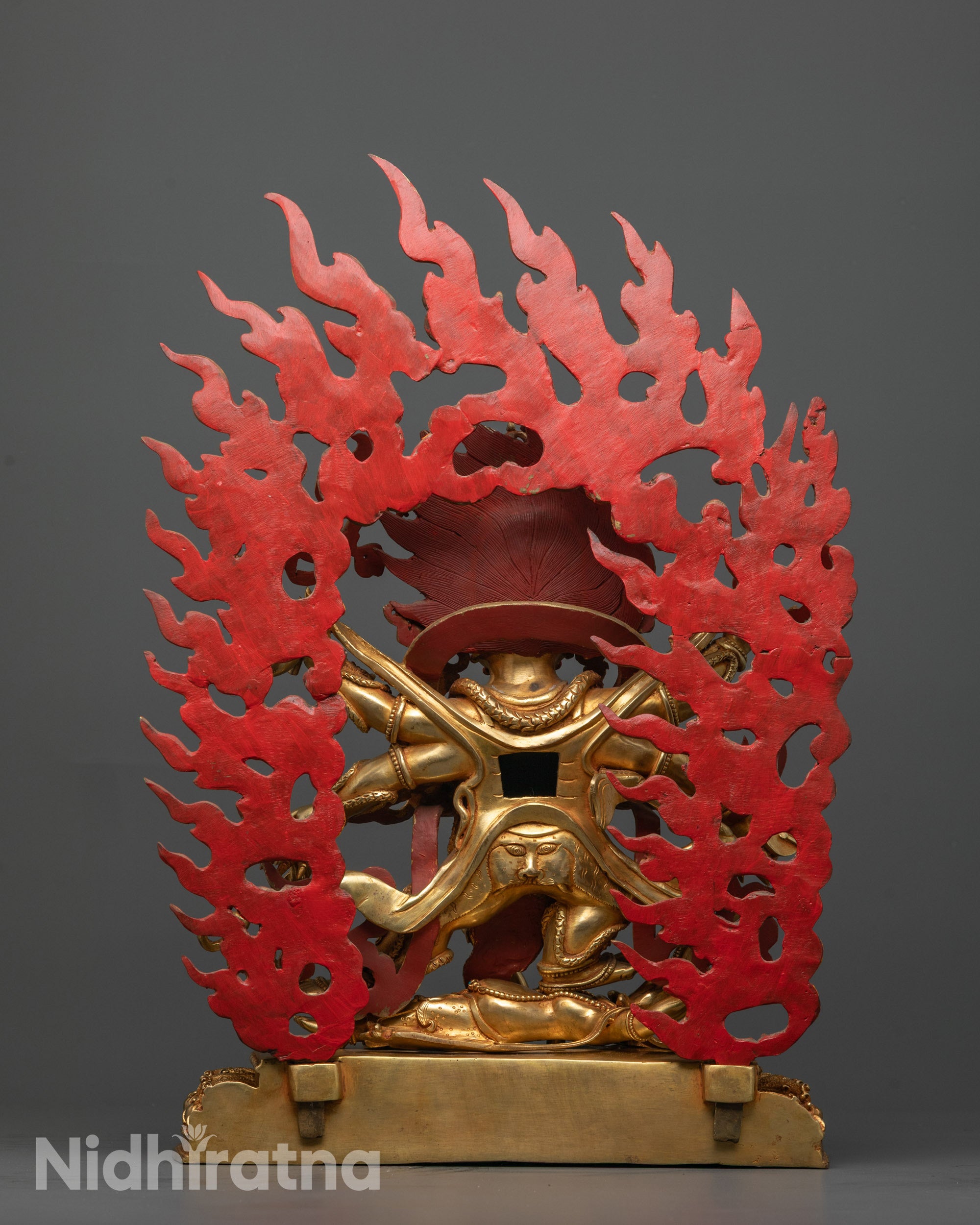 Rear angle of Six Armed Mahakala statue featuring detailed robe patterns