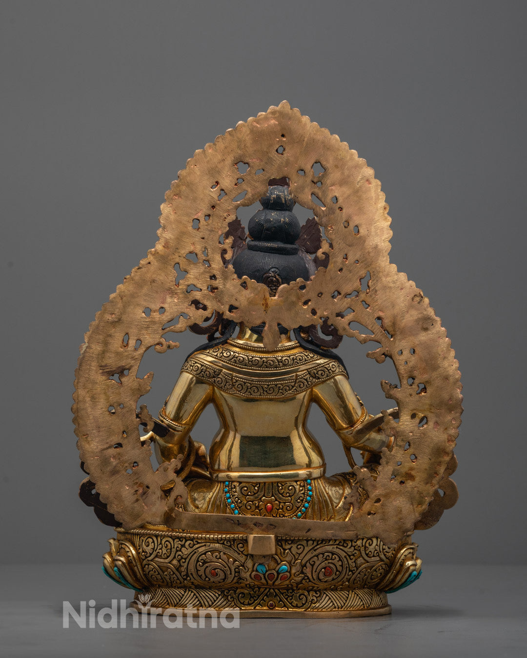 Rear view of Dzambhala Statue revealing fine detailing on the robes