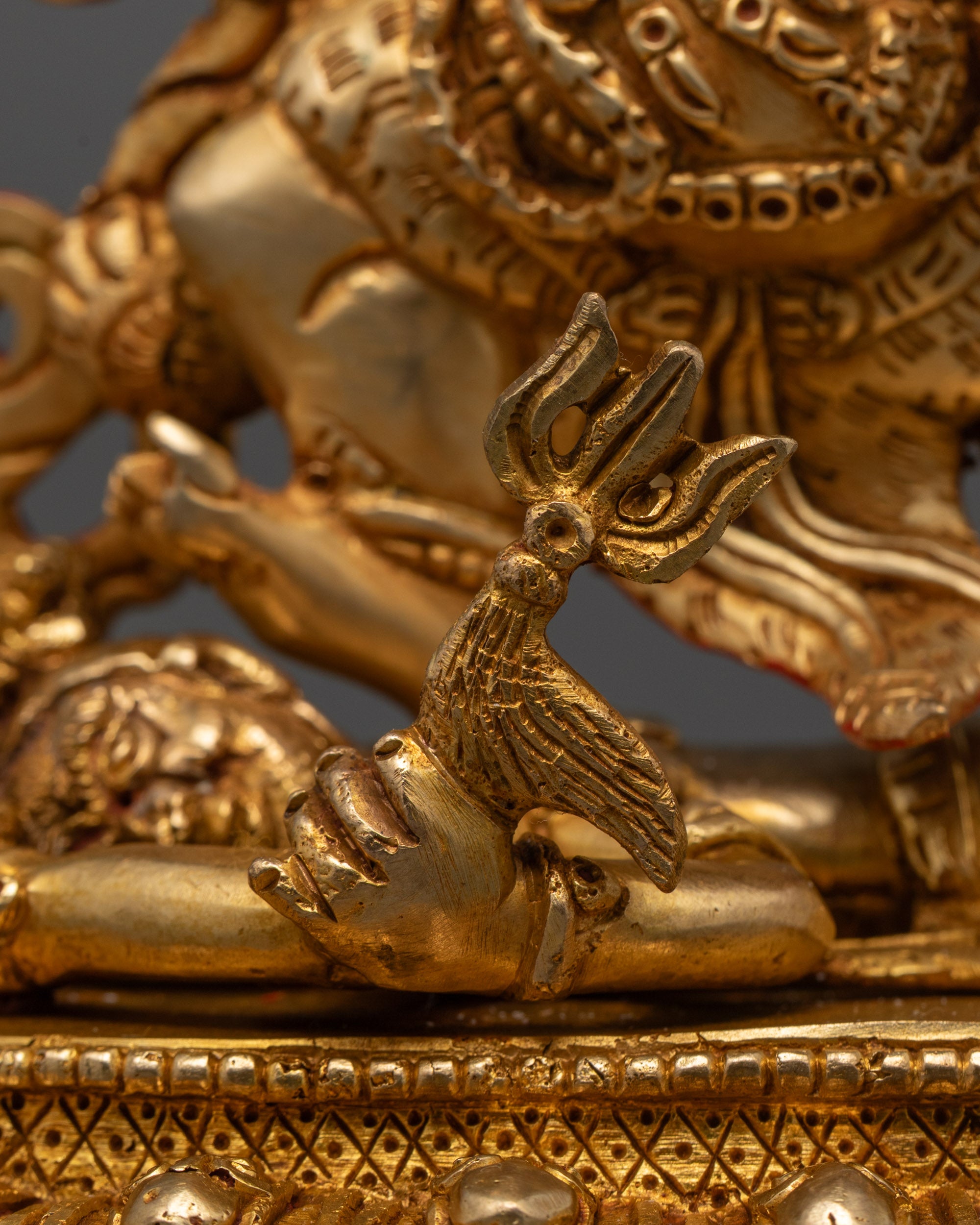 Rear view of Vajrapani statue highlighting detailed gold gilding, lotus base