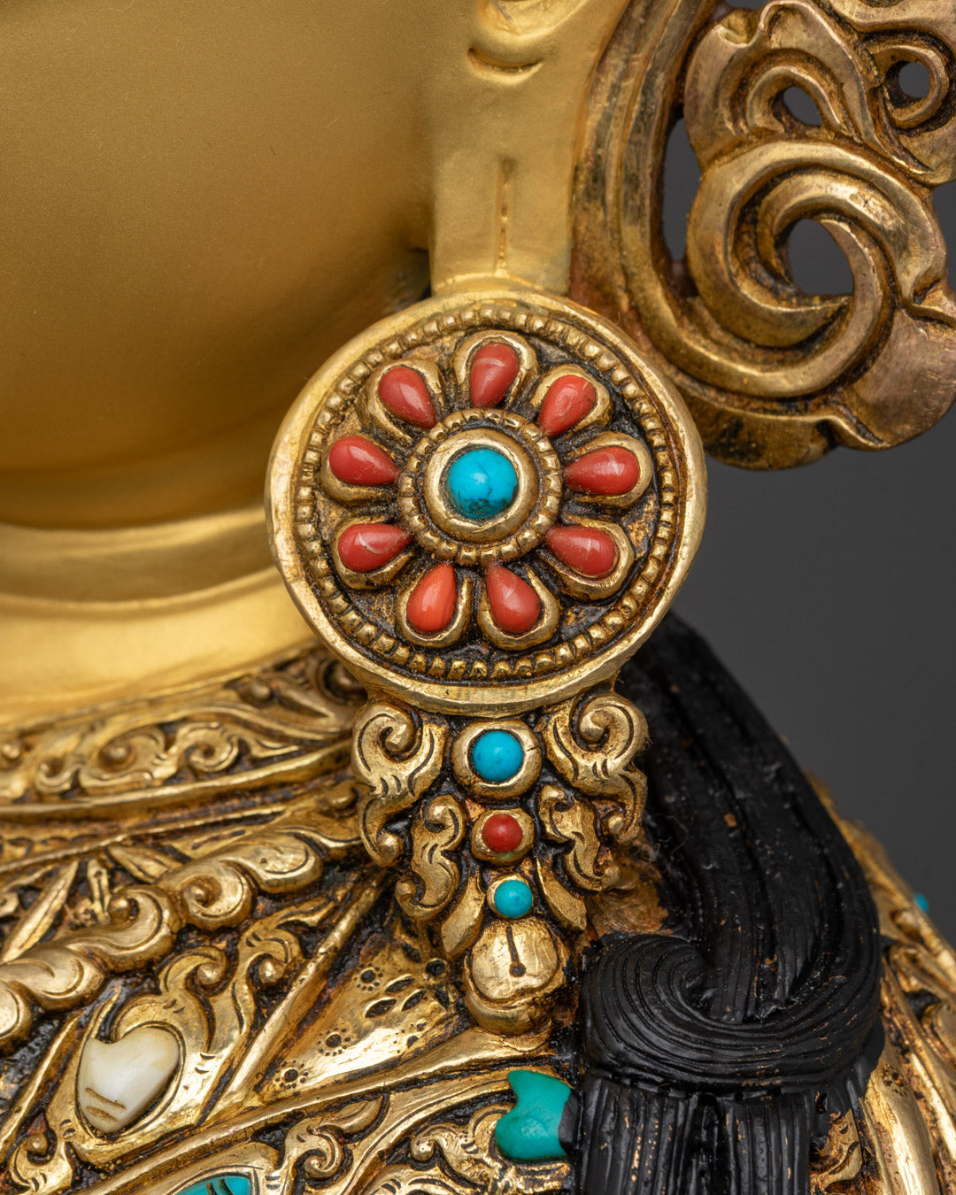 Rear view of copper-based Guru Rinpoche sculpture featuring ear ring