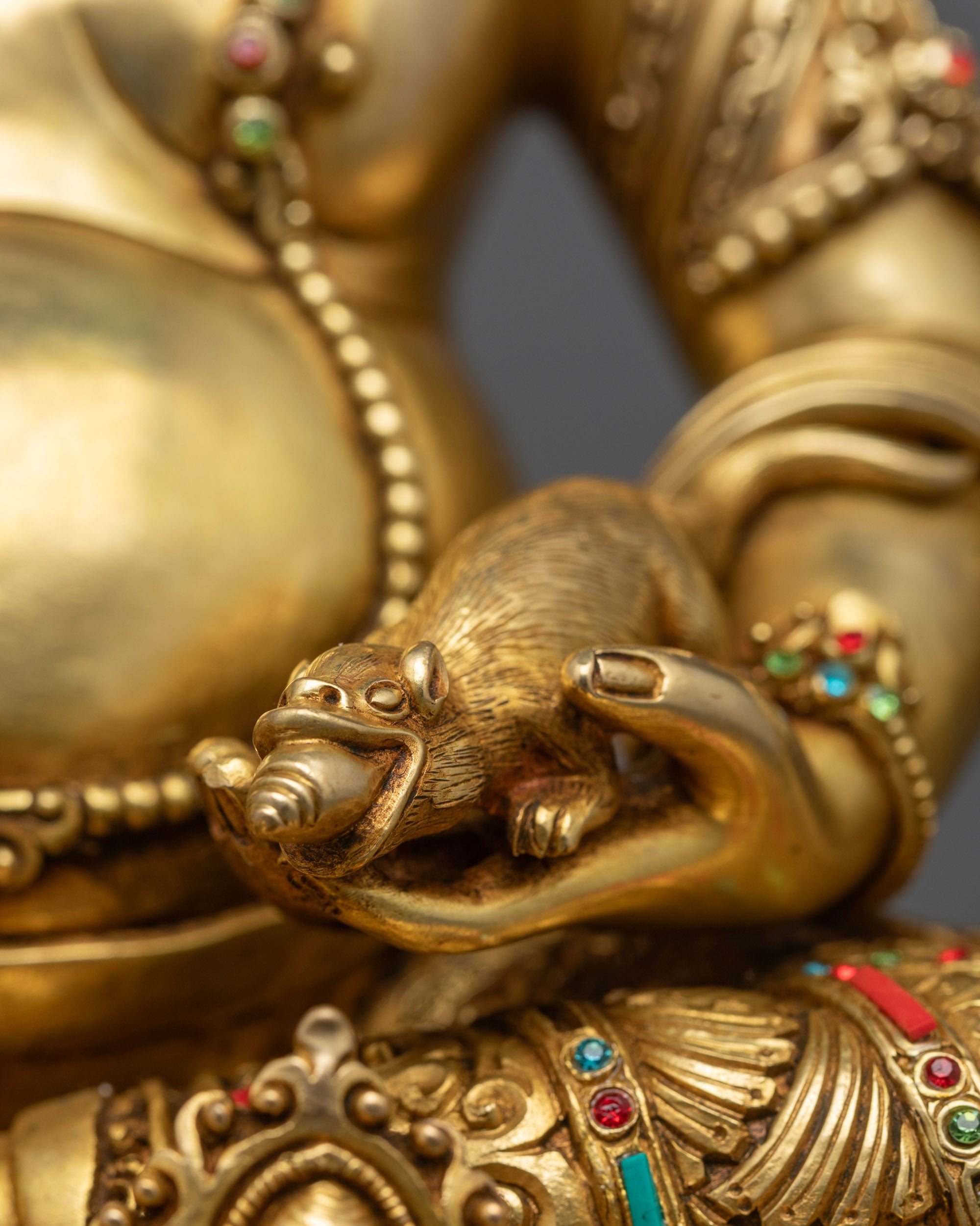 Rear view of detailed Dzambhala statue showcasing intricate craftsmanship and fire gold gilding