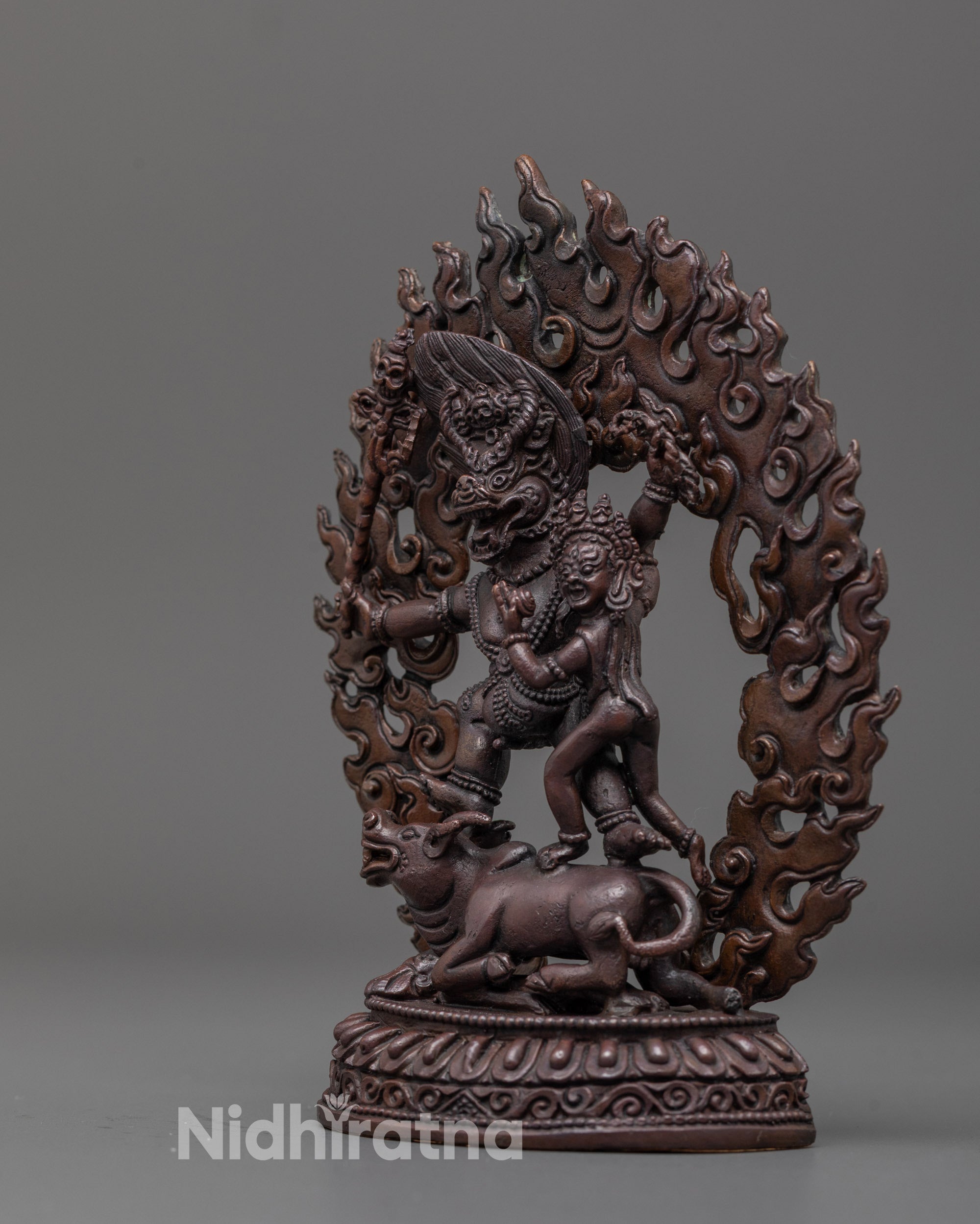 Rear view of intricately detailed Yama Dharmaraja and Consort Statue showing flame halo