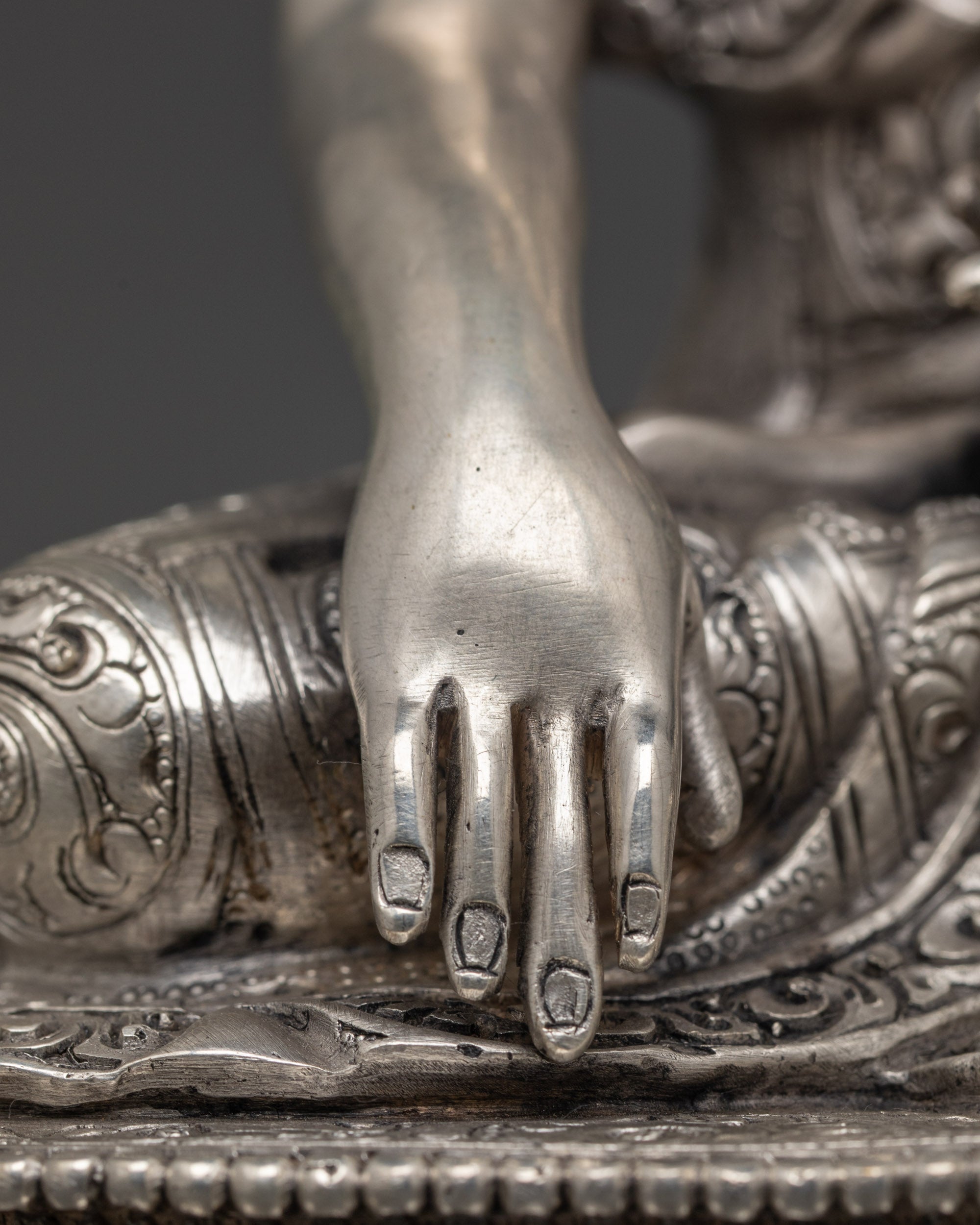 Rear view of silver-plated Shakyamuni Buddha Statue showing lotus base