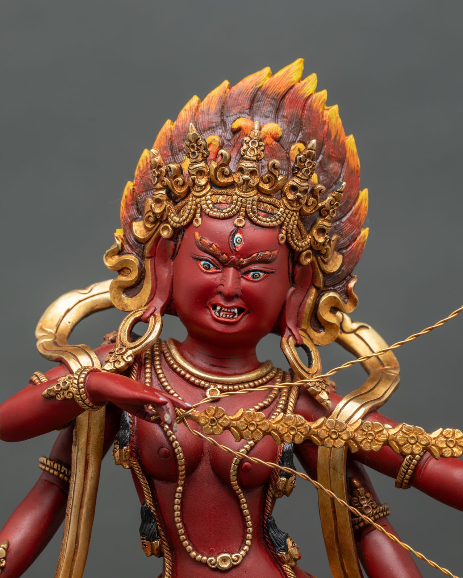 Regular close-up of Kurukulla deity statue, intricate 3D carvings on lotus pedestal