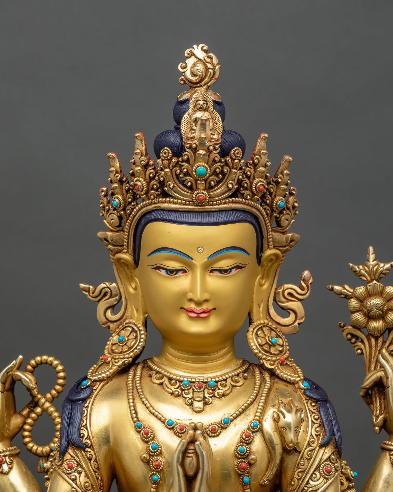 Regular close-up of Chenrezig statue showing intricate lotus pedestal and hand details