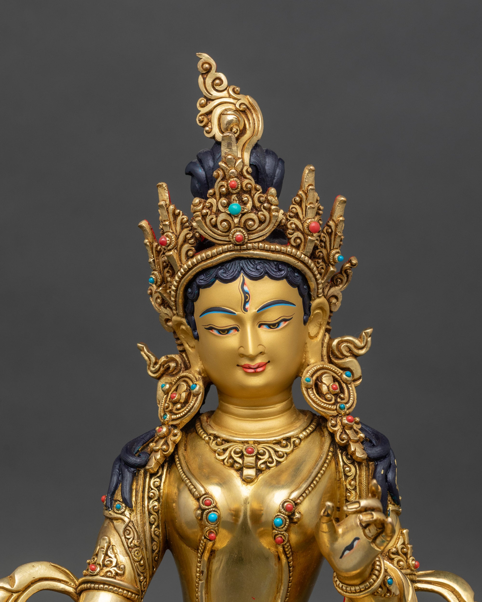 Regular close-up of Dukar statue showing intricate jeweled crown and ornaments