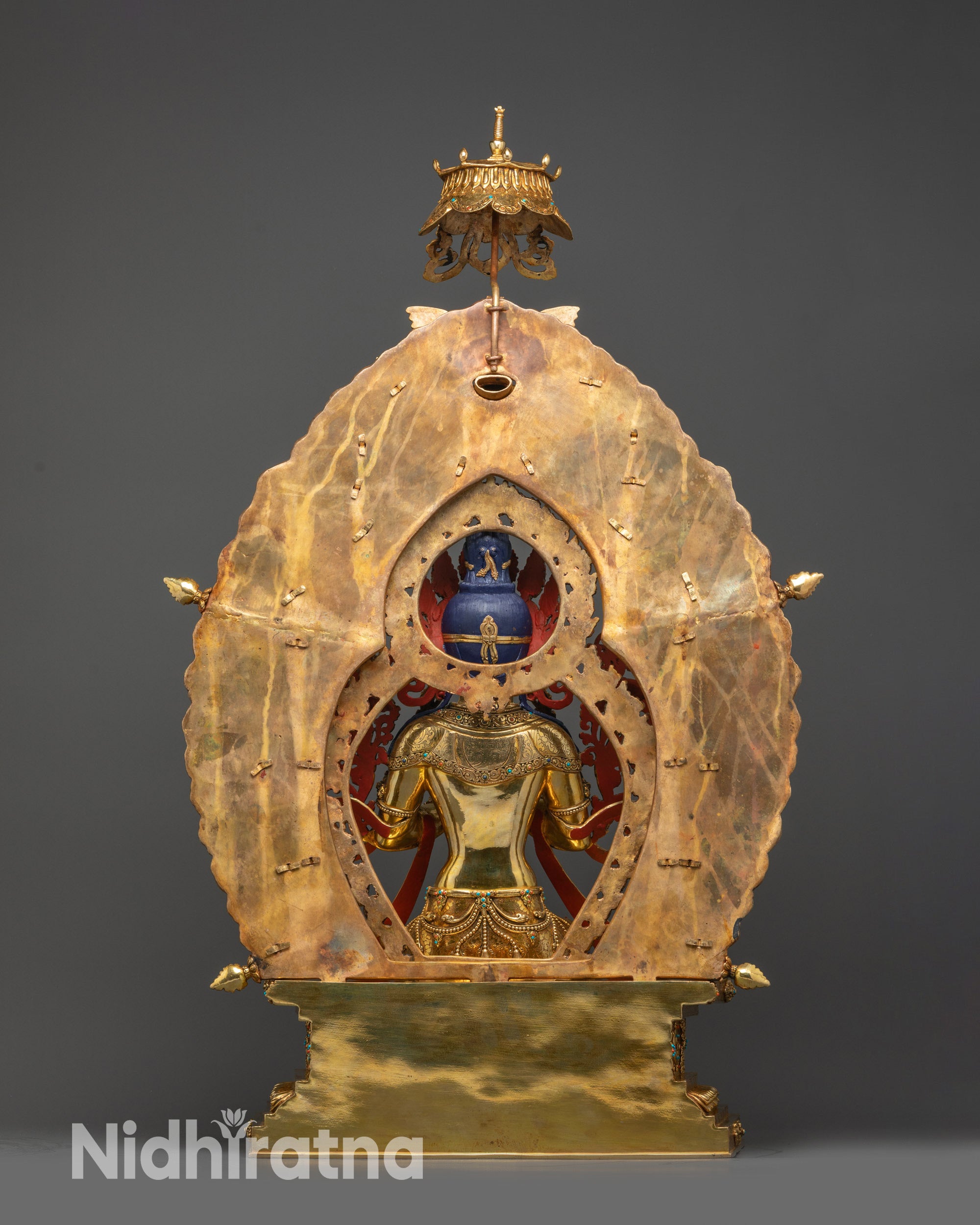 Regular back view Maitreya Buddha statue showing carved halo and robe folds