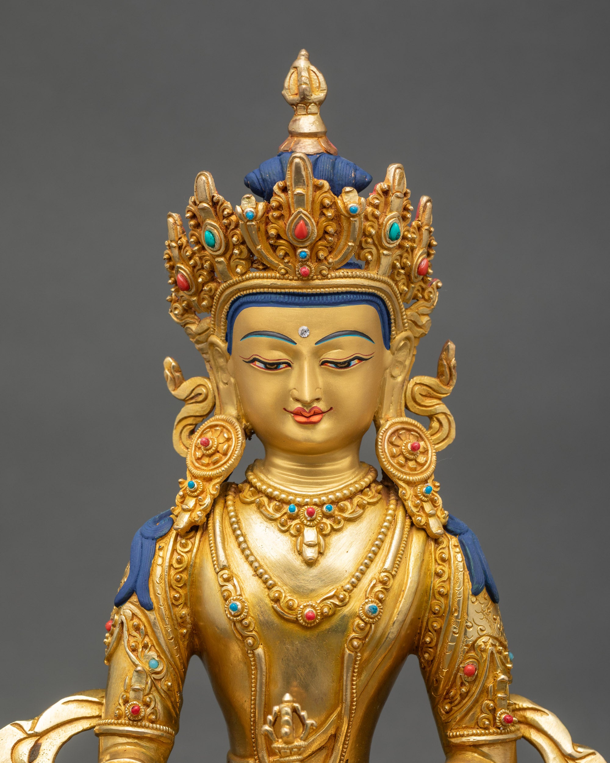 Regular close-up of Mitrugpa sculpture showing intricate copper and gold details