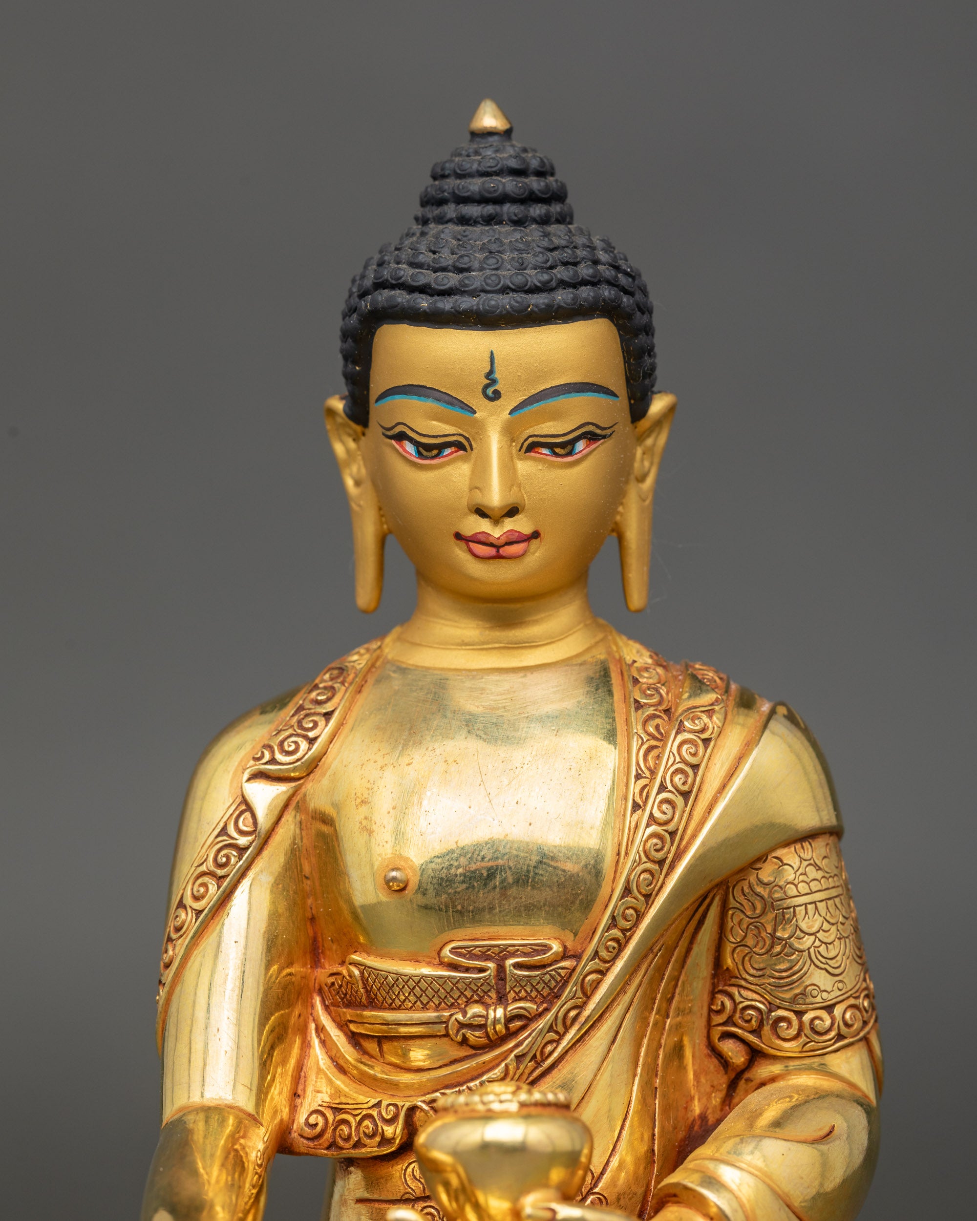 Regular close-up of Shakyamuni Buddha sculpture, detailed copper craftsmanship