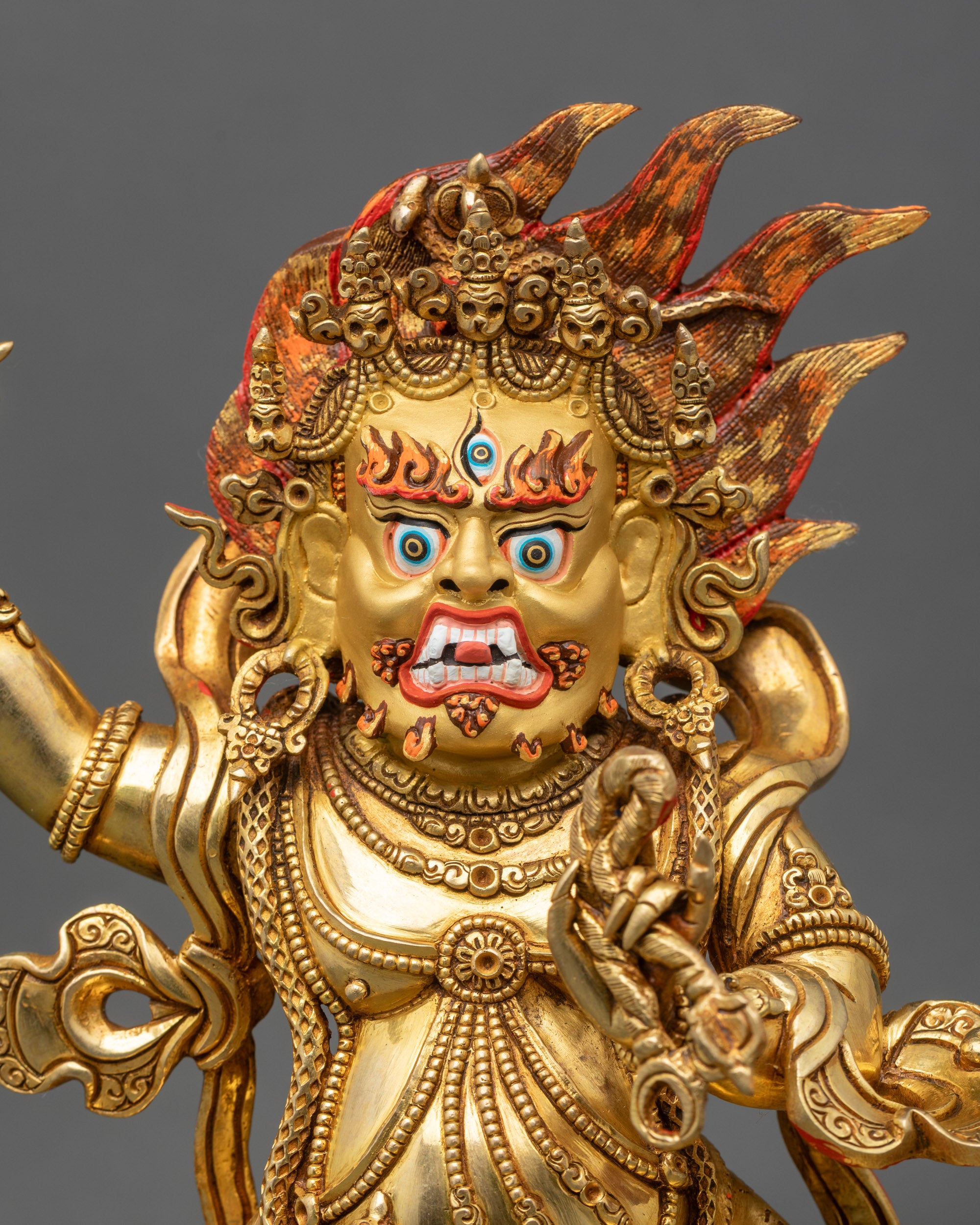 Regular close-up of Vajrapani Statue showing intricate 3D copper carvings and gold fire-gilding