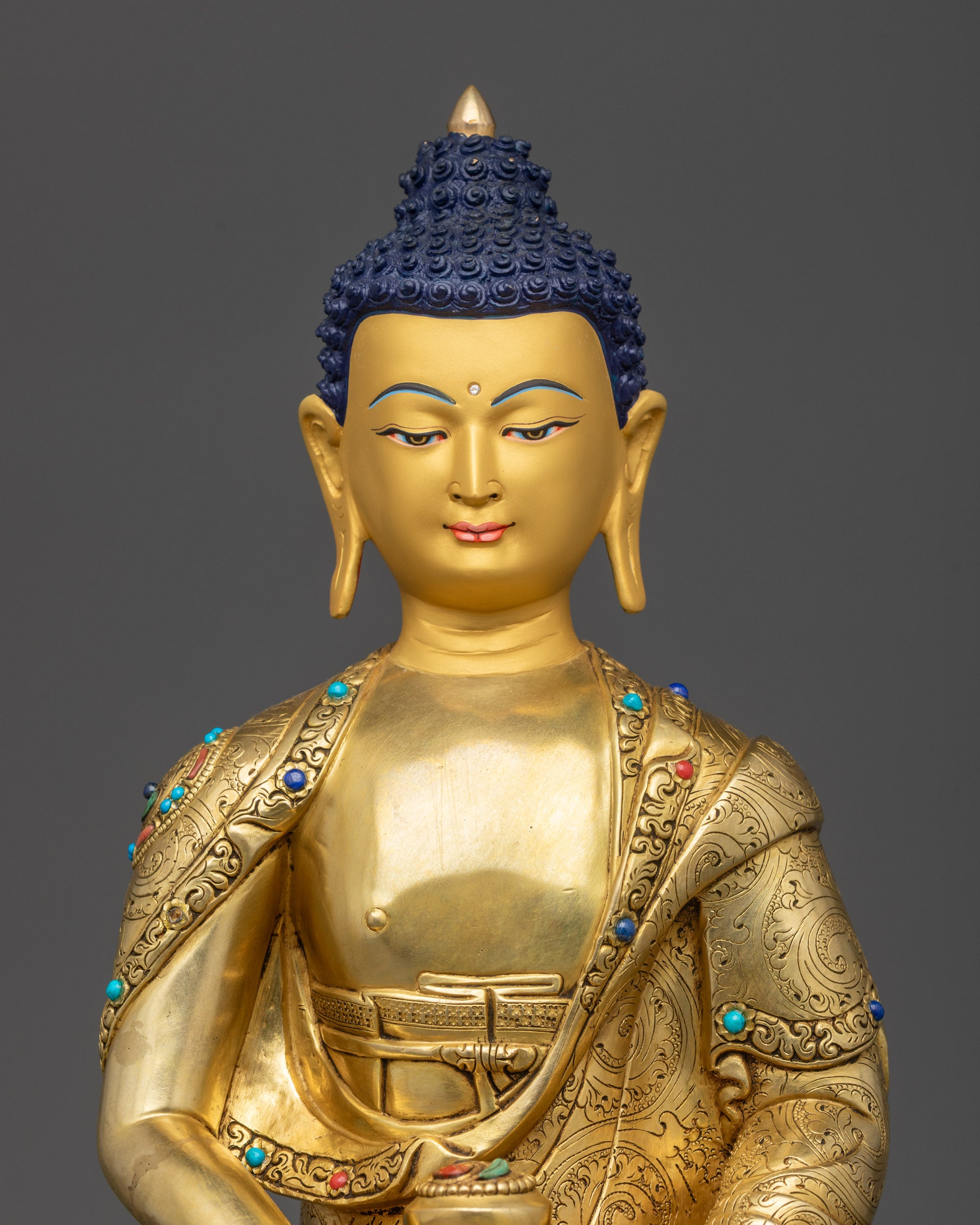 Regular close up Amitabha Buddha gold-gilded meditation statue showing serene details