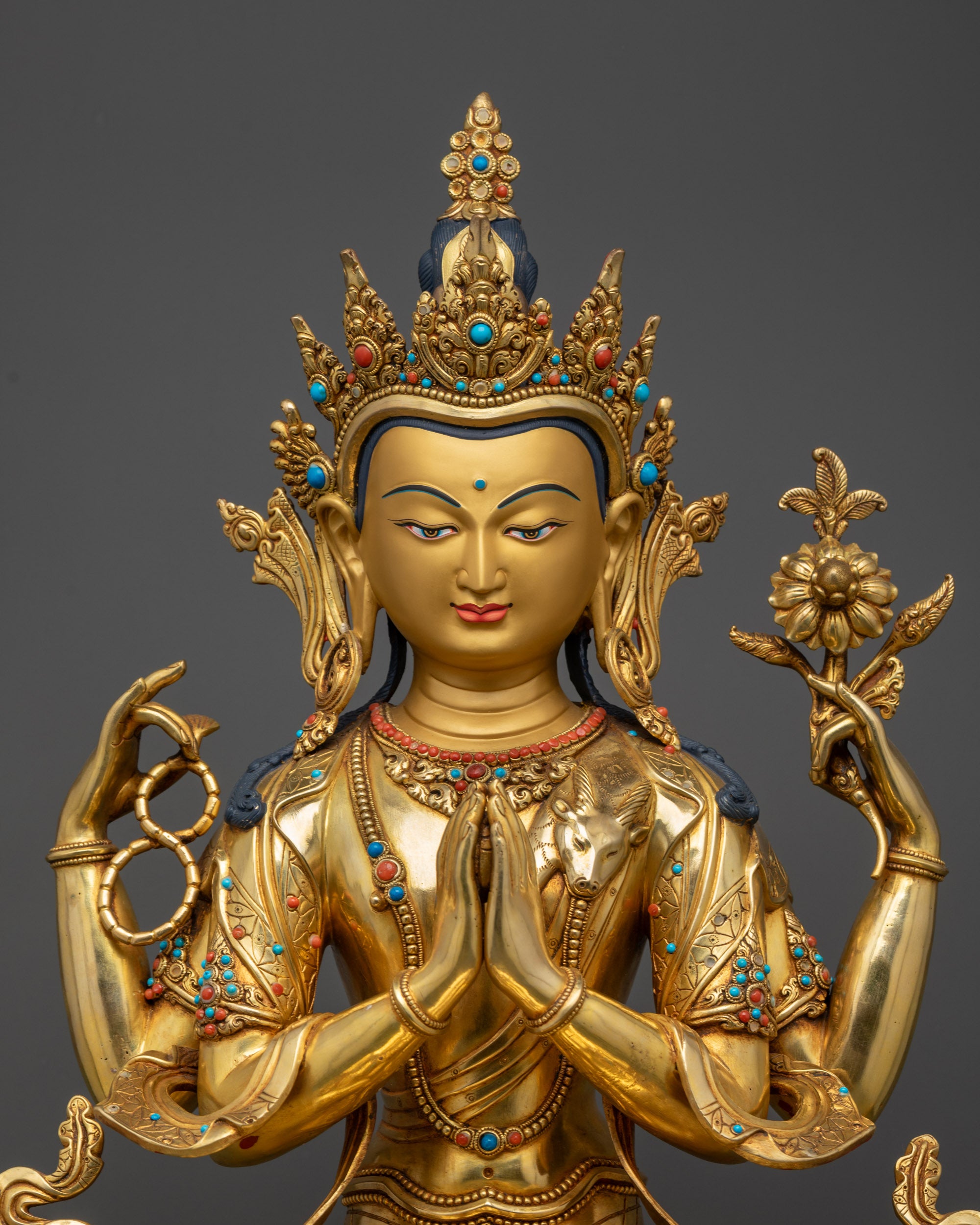 Regular close up Chenrezig statue showing flowing robes and four arms