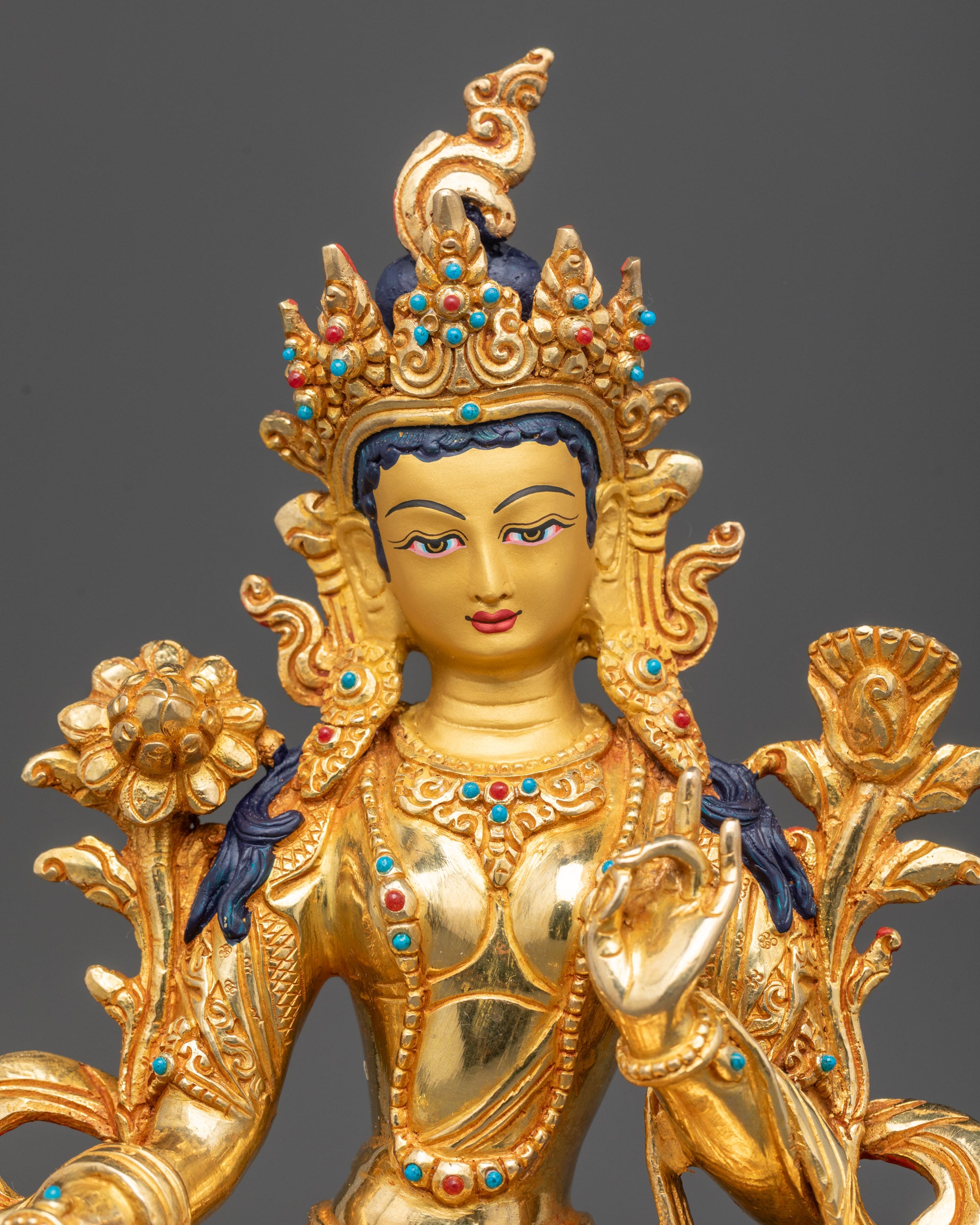Regular close up Green Tara sculpture showing jeweled crown and Utpala flower