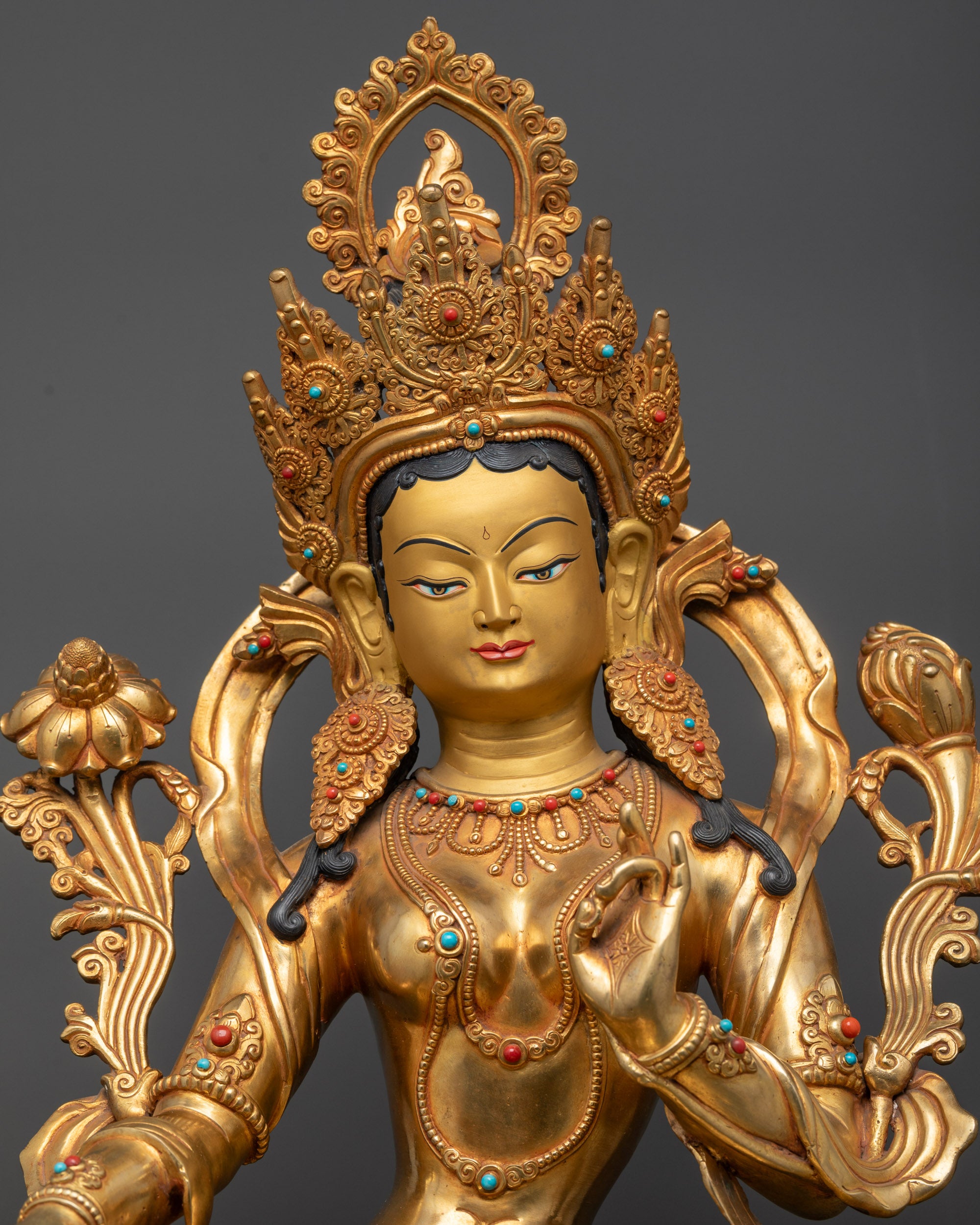 Regular close up Green Tara statue holding utpala flower beside her shoulder gracefully