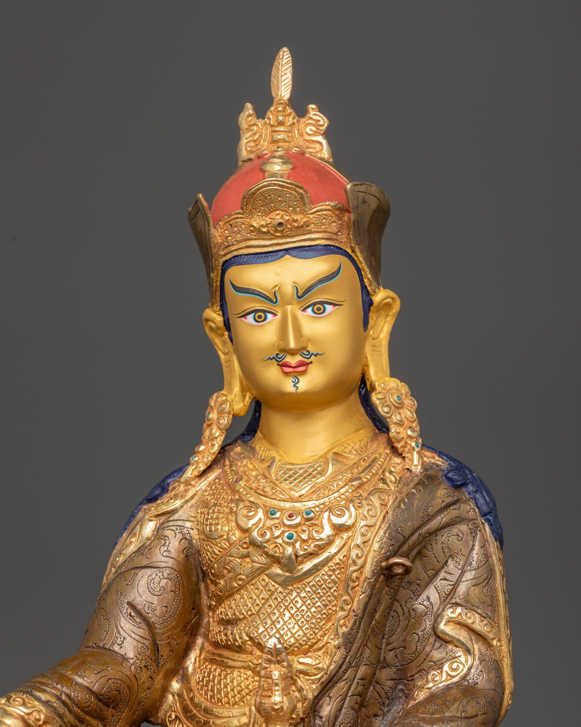 Regular close up Guru Padmasambhava statue showing kasaya robe and lotus hat details
