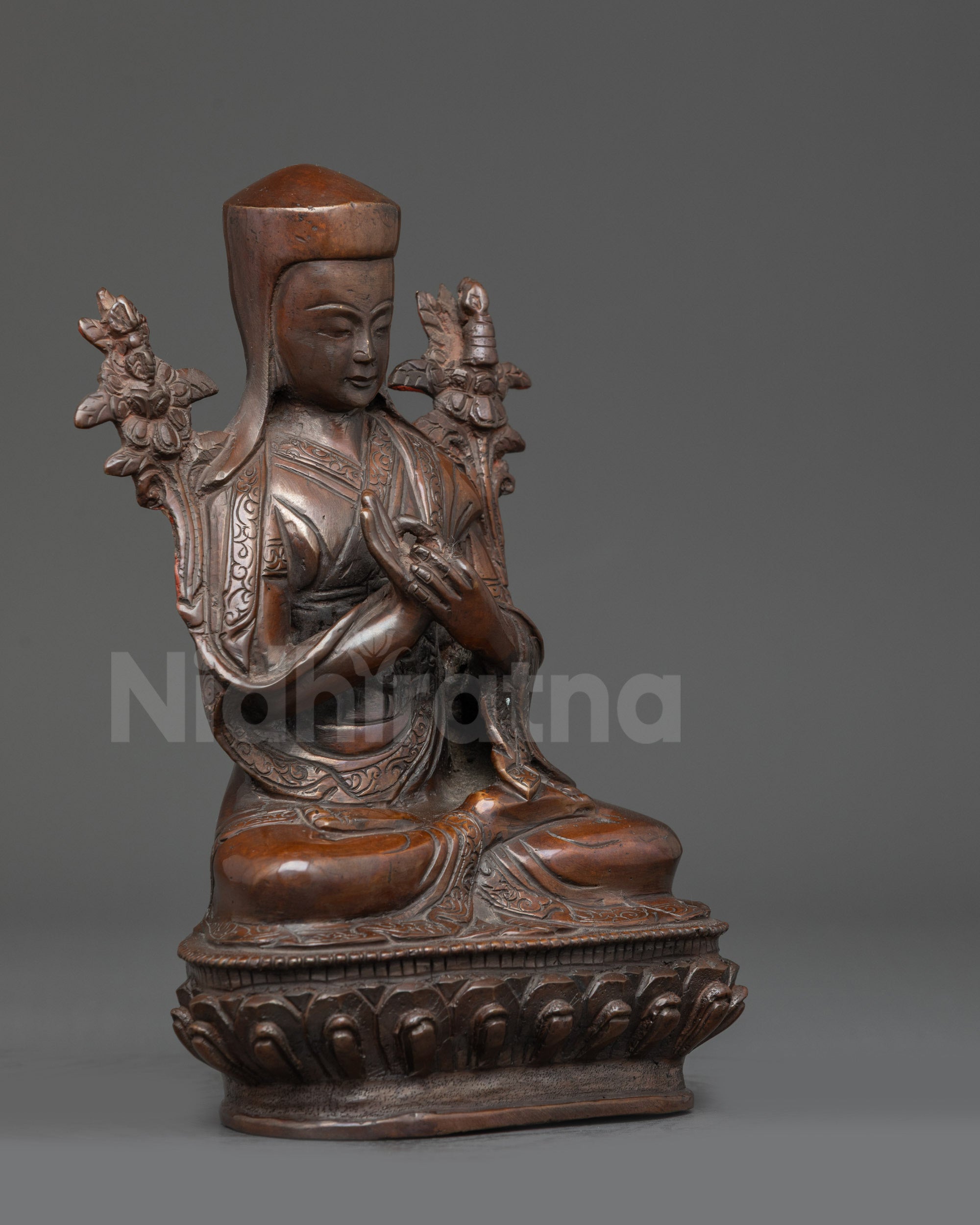 Regular close up Je Tsongkhapa Statue intricate robes motifs and sacred details visible