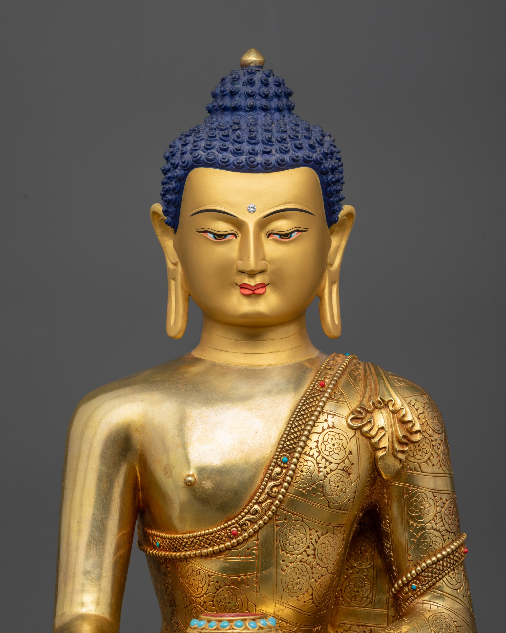 Regular close up Shakyamuni Buddha statue showing serene expression and intricate details