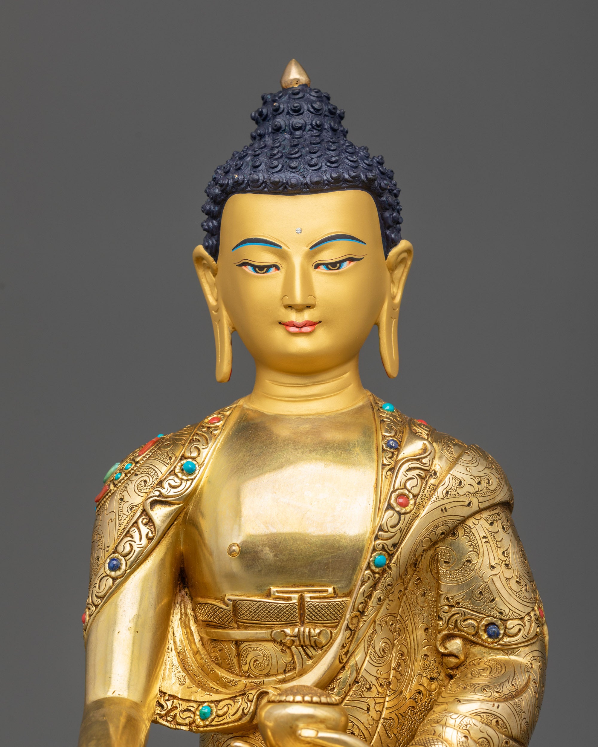 Regular close up Shakyamuni Buddha statue showing serene posture and detailed robe