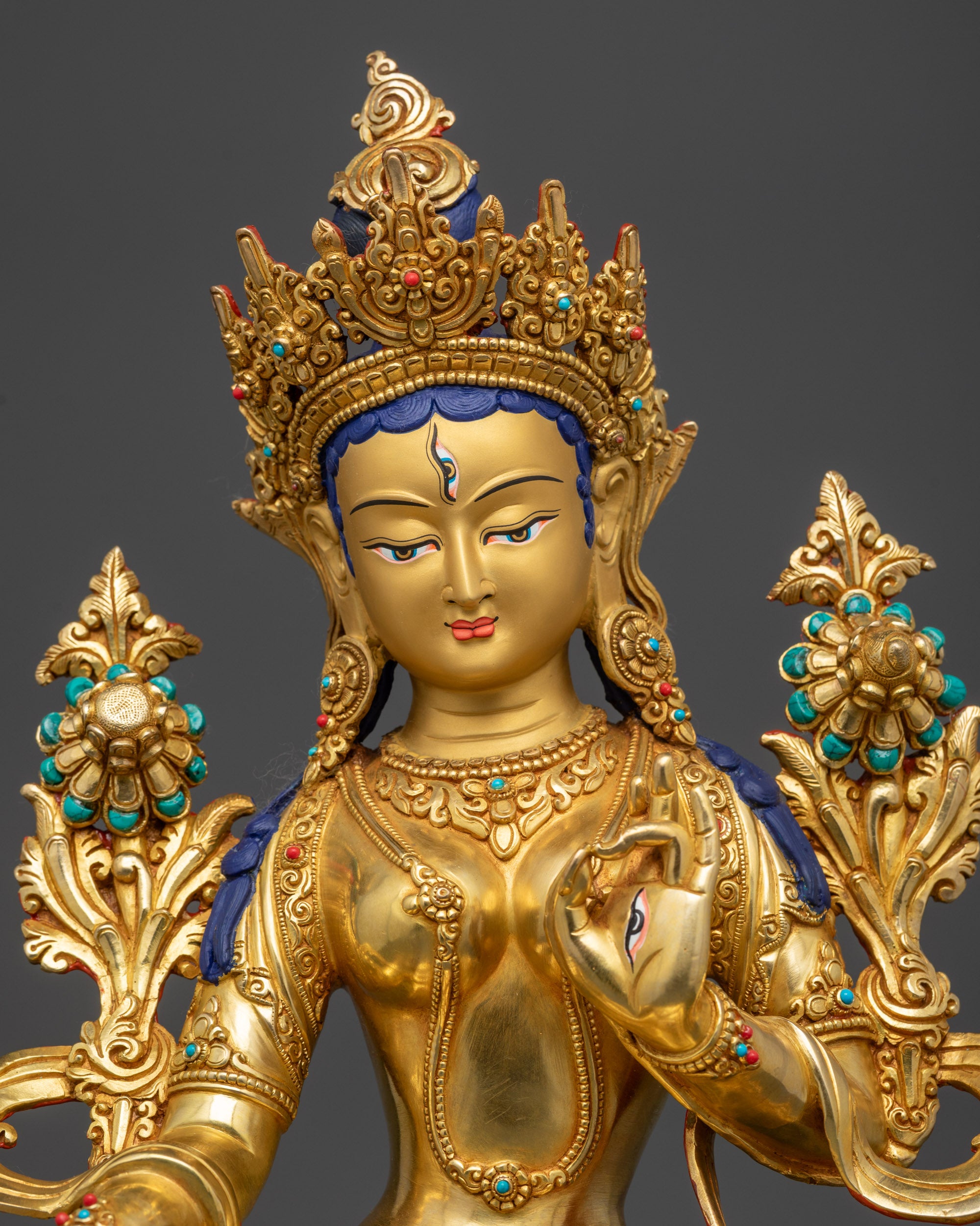 Regular close up White Tara holding utpala stem with blooming flowers and flowing robe