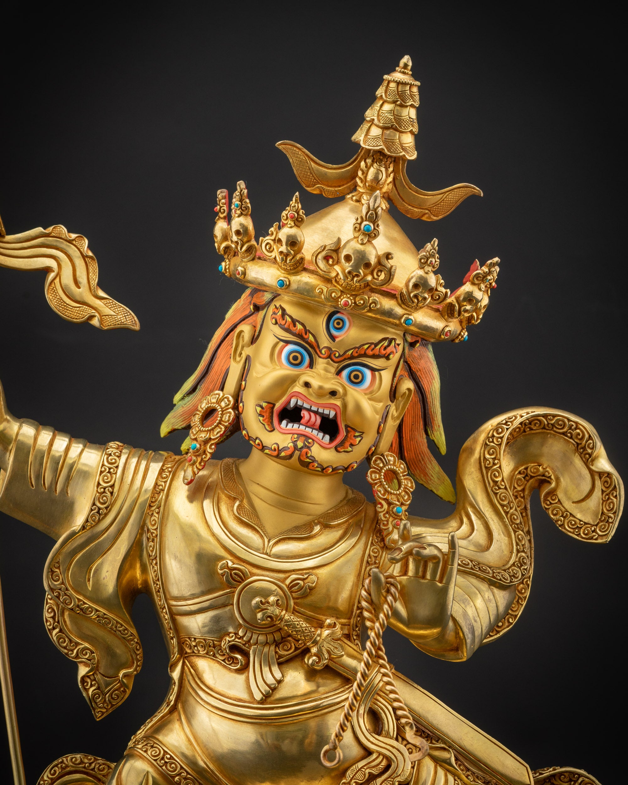 Regular close up face of Nechung Chuyong Statue showing fierce gaze and expression