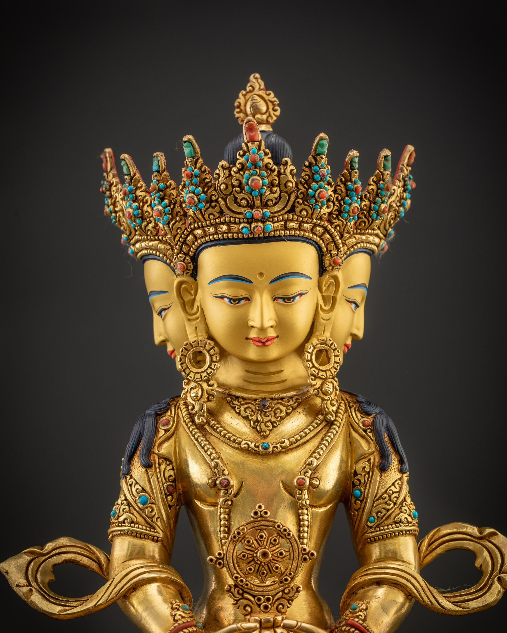 Regular close up front Vairocana Buddha gold-gilded faces with five-jeweled crown and gemstones