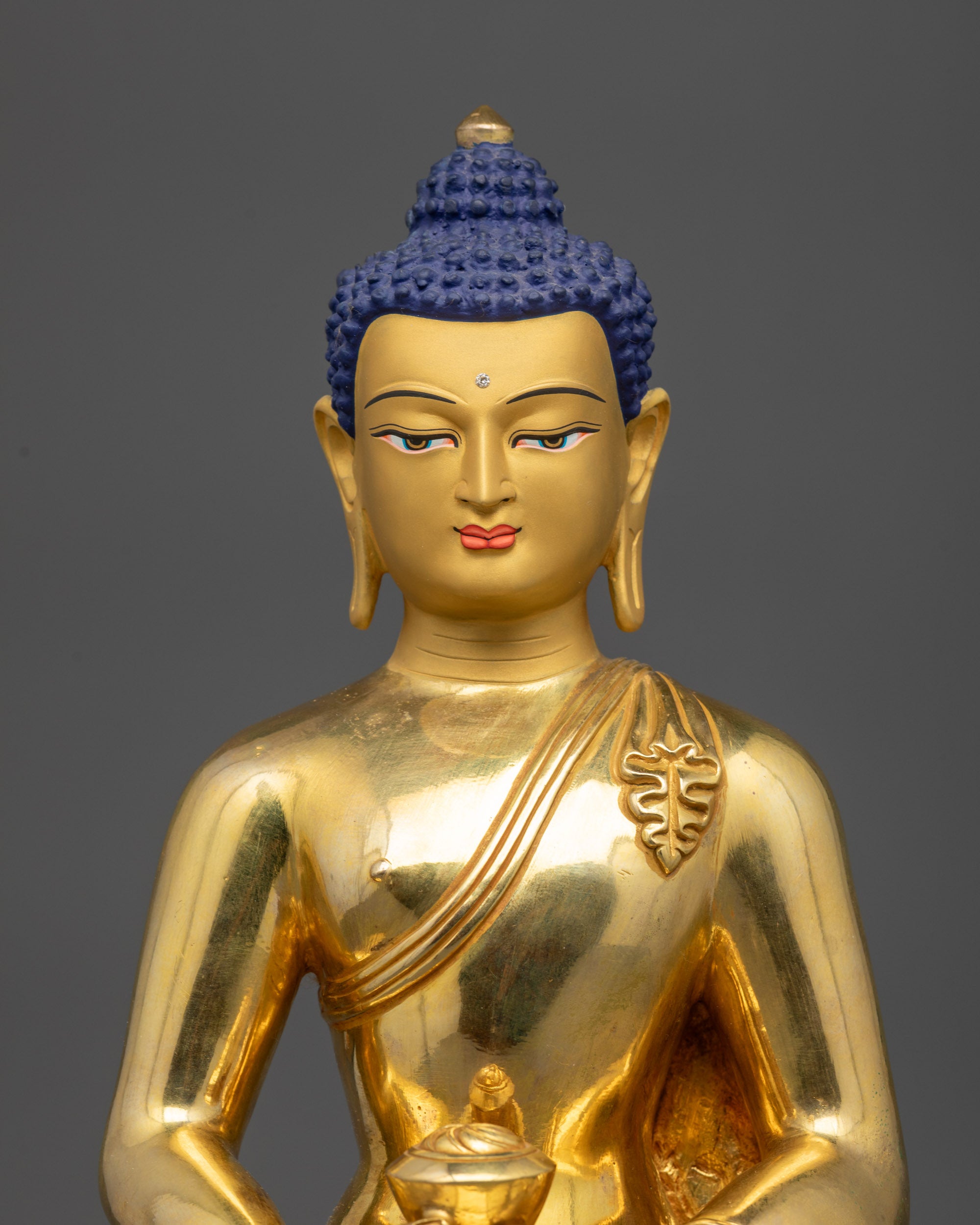 Regular close up of Amitabha Buddha Pure Land sculpture showing carved monk's robe