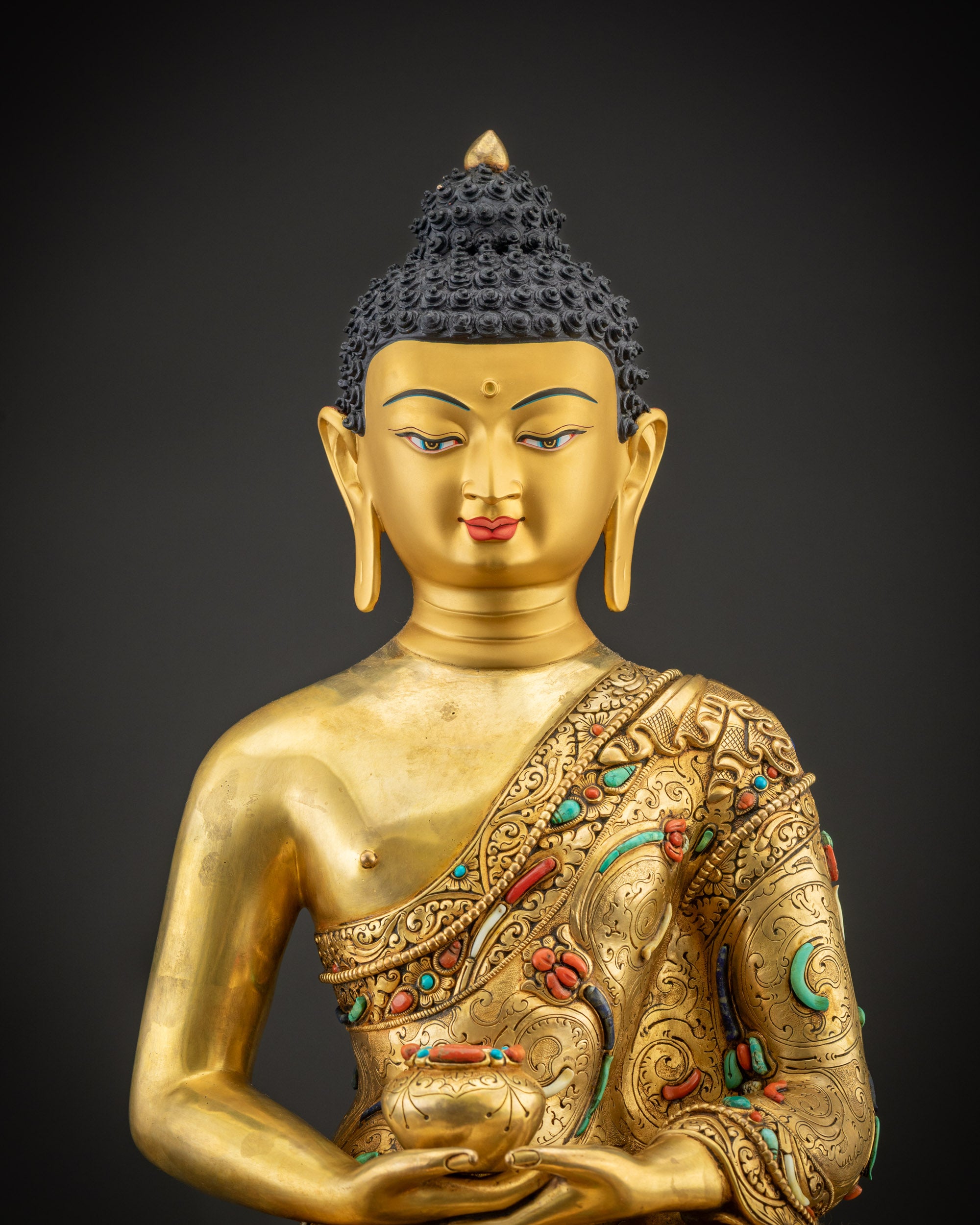Regular close up of Amitabha Buddha Statue, gold face and gemstone halo details