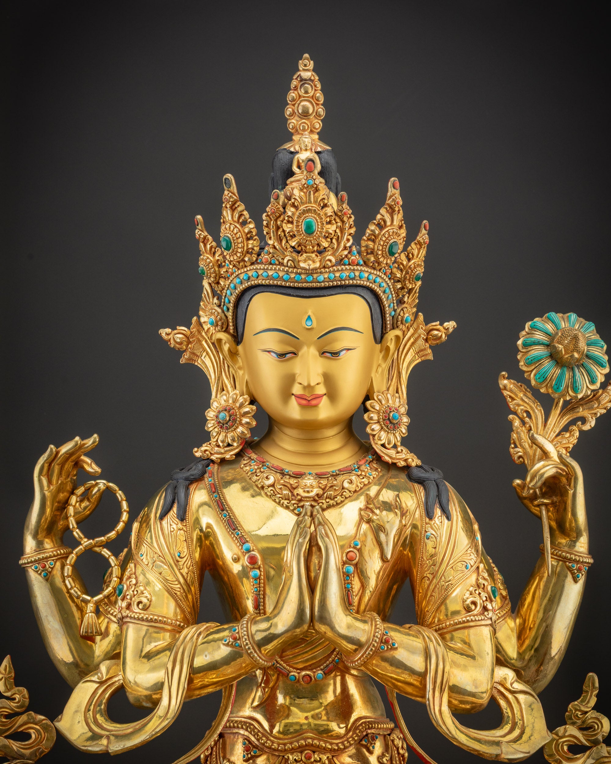 Regular close up of Chenrezig Statue showing hand-carved floral motifs and semi-precious stones