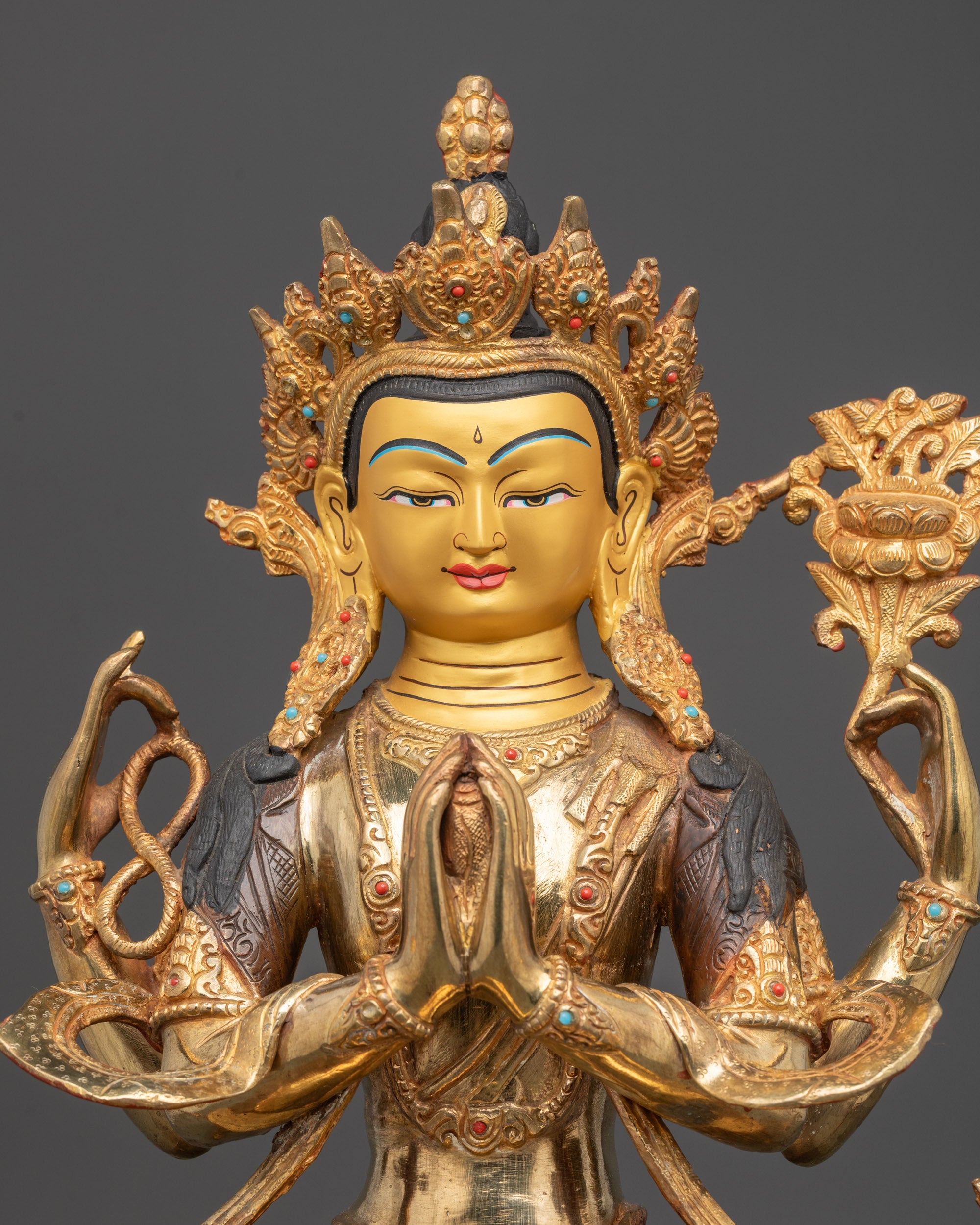 Regular close up of Chenrezig Statue showing lotus, prayer beads, and blessing hand
