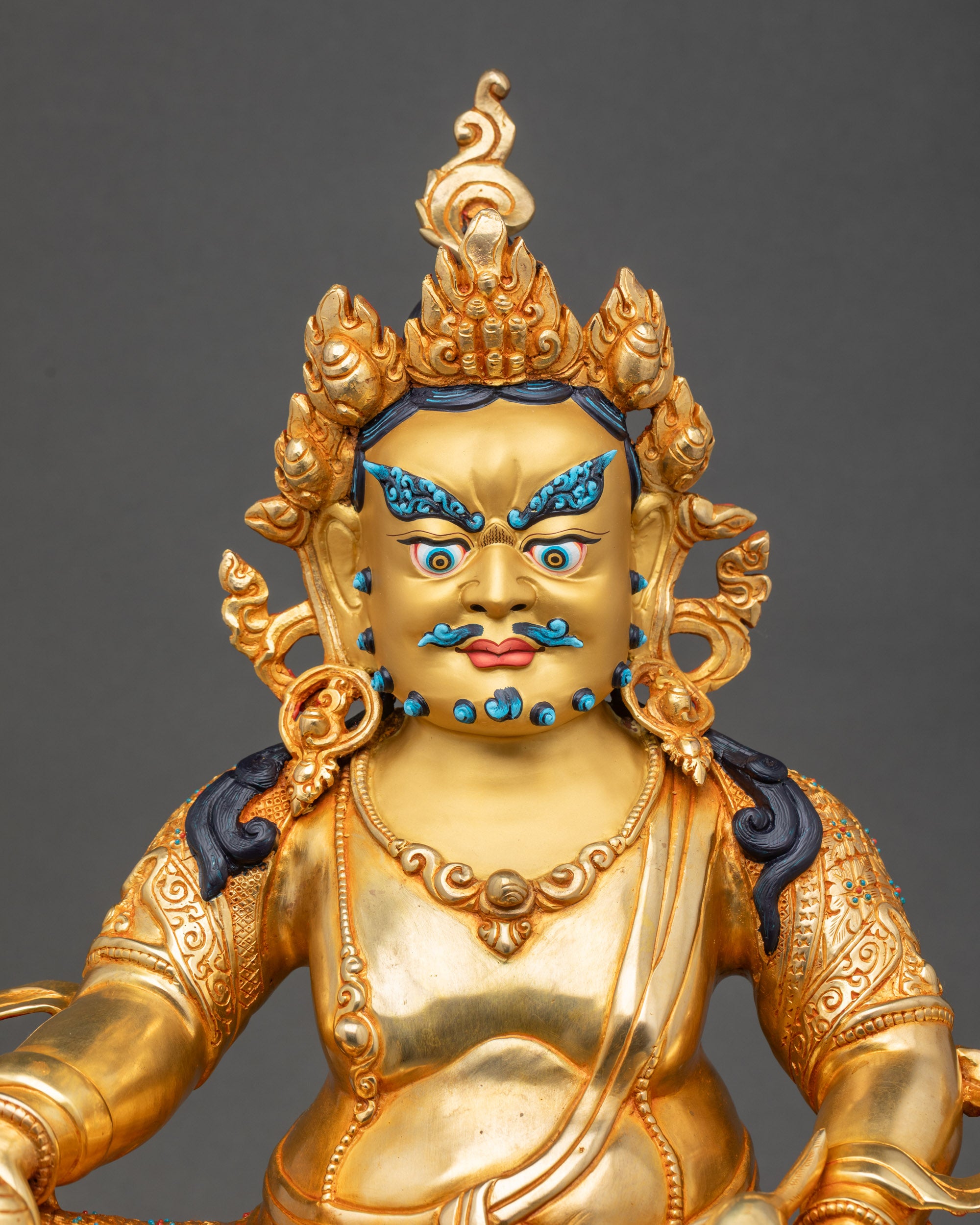 Regular close up of Dzambhala Statue showing wrathful expression and jeweled crown