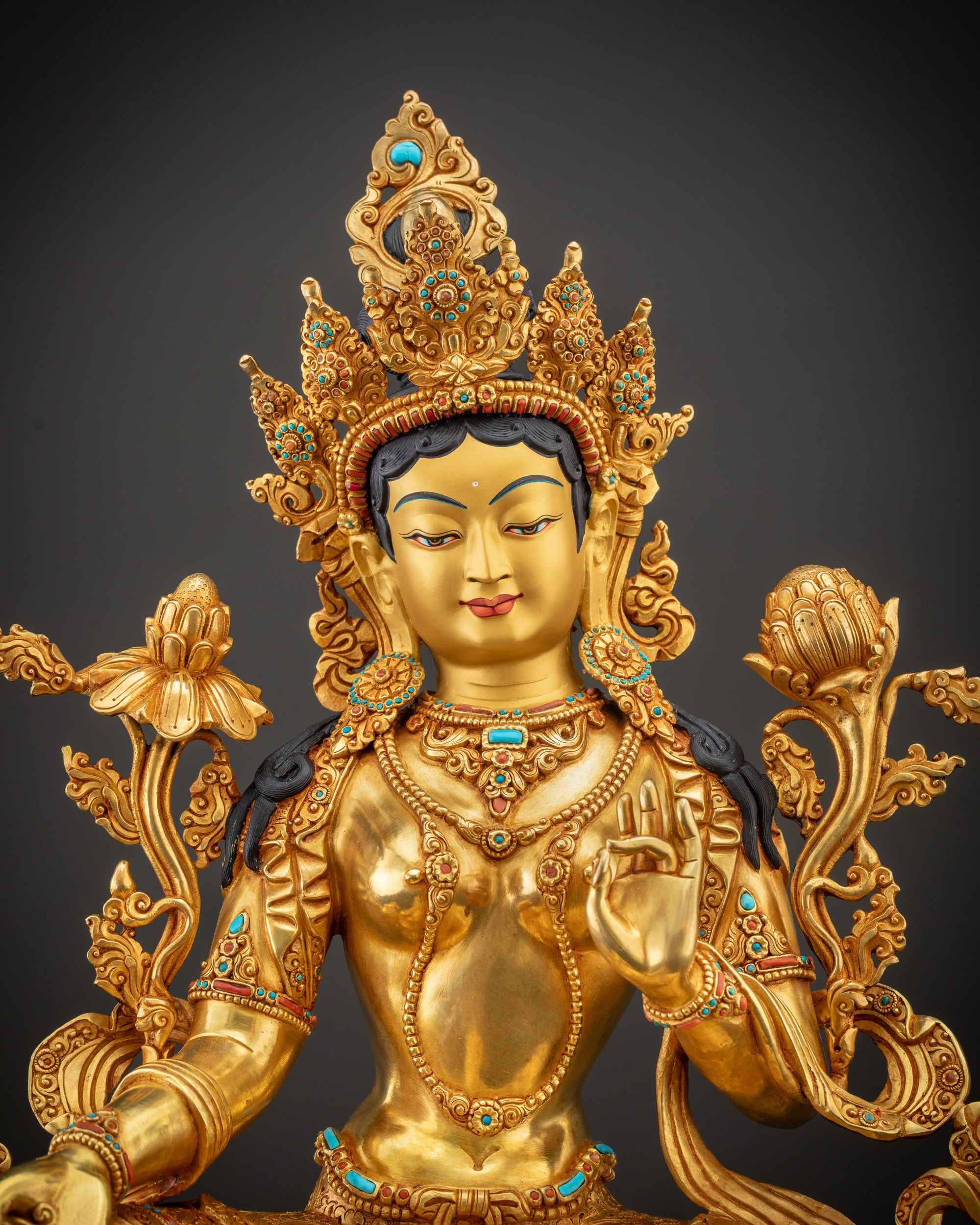 Regular close up of Green Tara face highlighting semi-precious stones and features