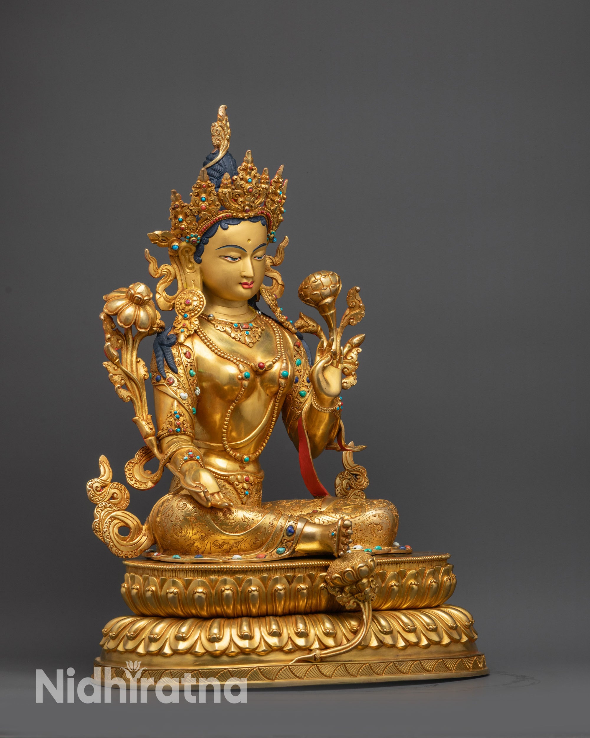 Regular close up of Green Tara showing right hand in Varada Mudra for generosity and blessings