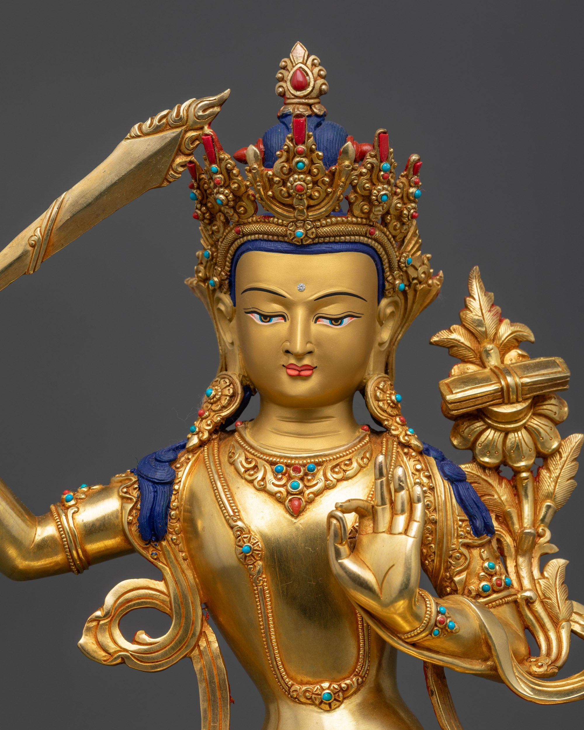 Regular close up of Manjushri Bodhisattva statue showing robe and garment details