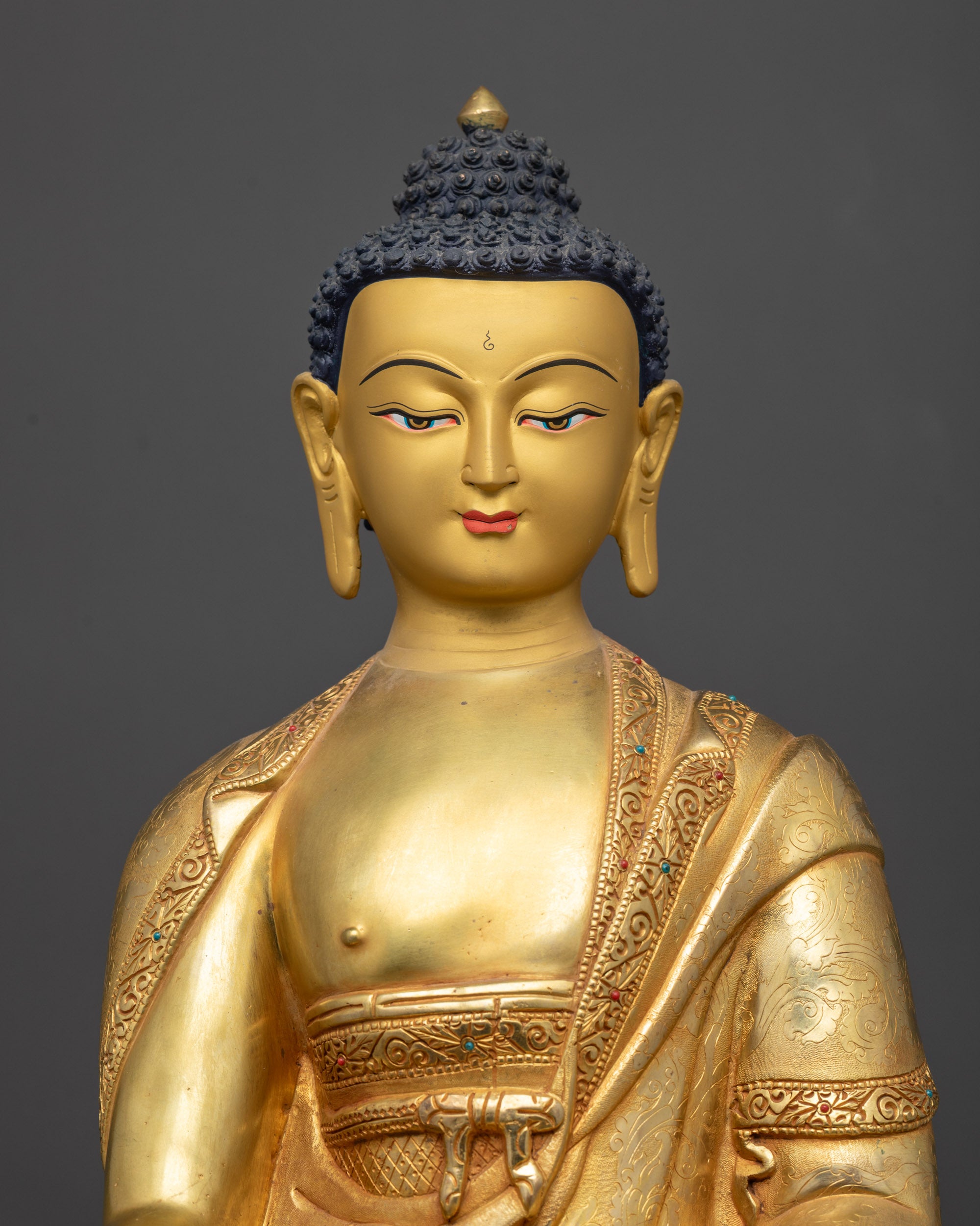 Regular close up of Medicine Buddha Bhaisajyaguru showing intricate robe and semi-precious stones