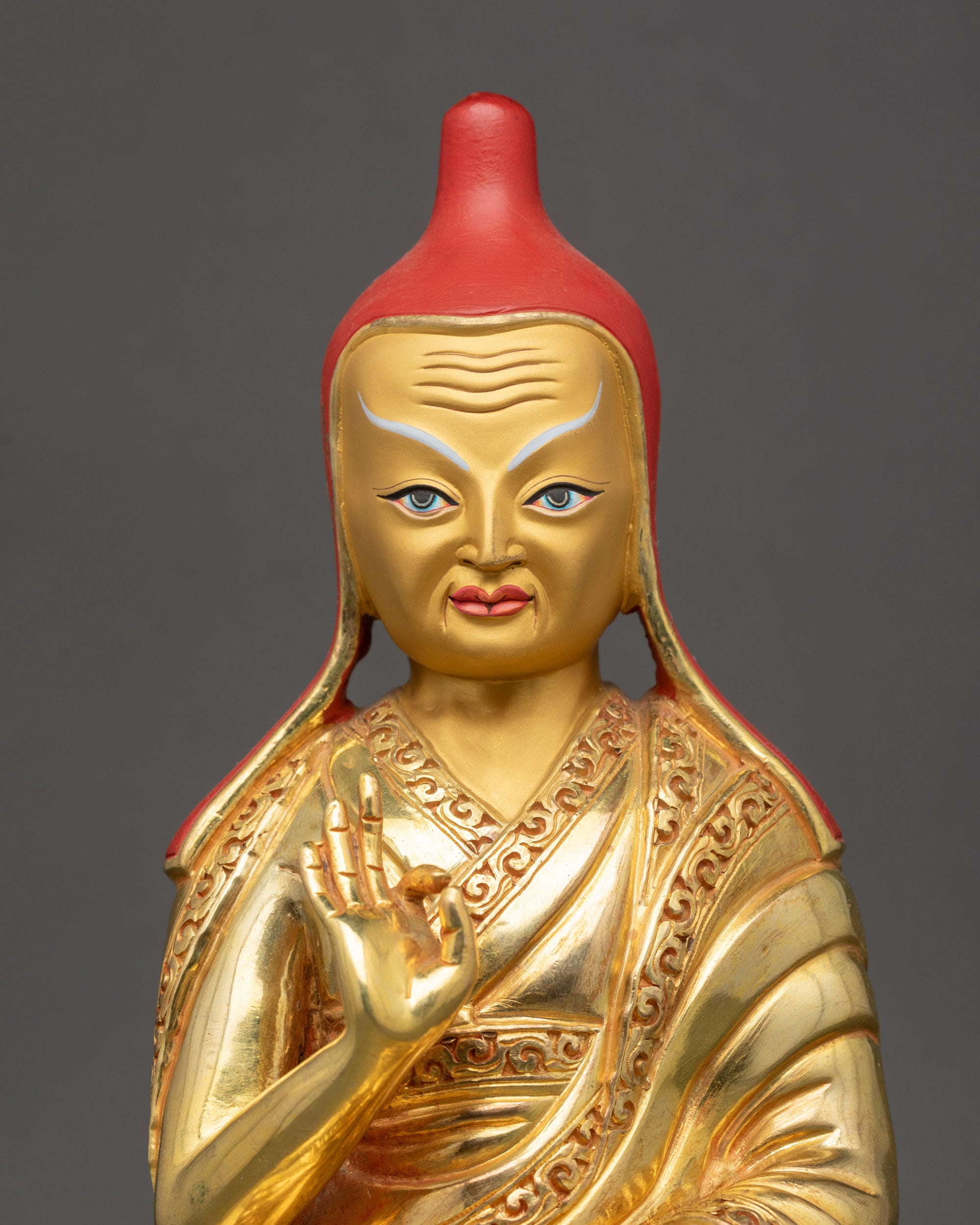 Regular close up of Santarakshita with yellow lama hat and sacred texts