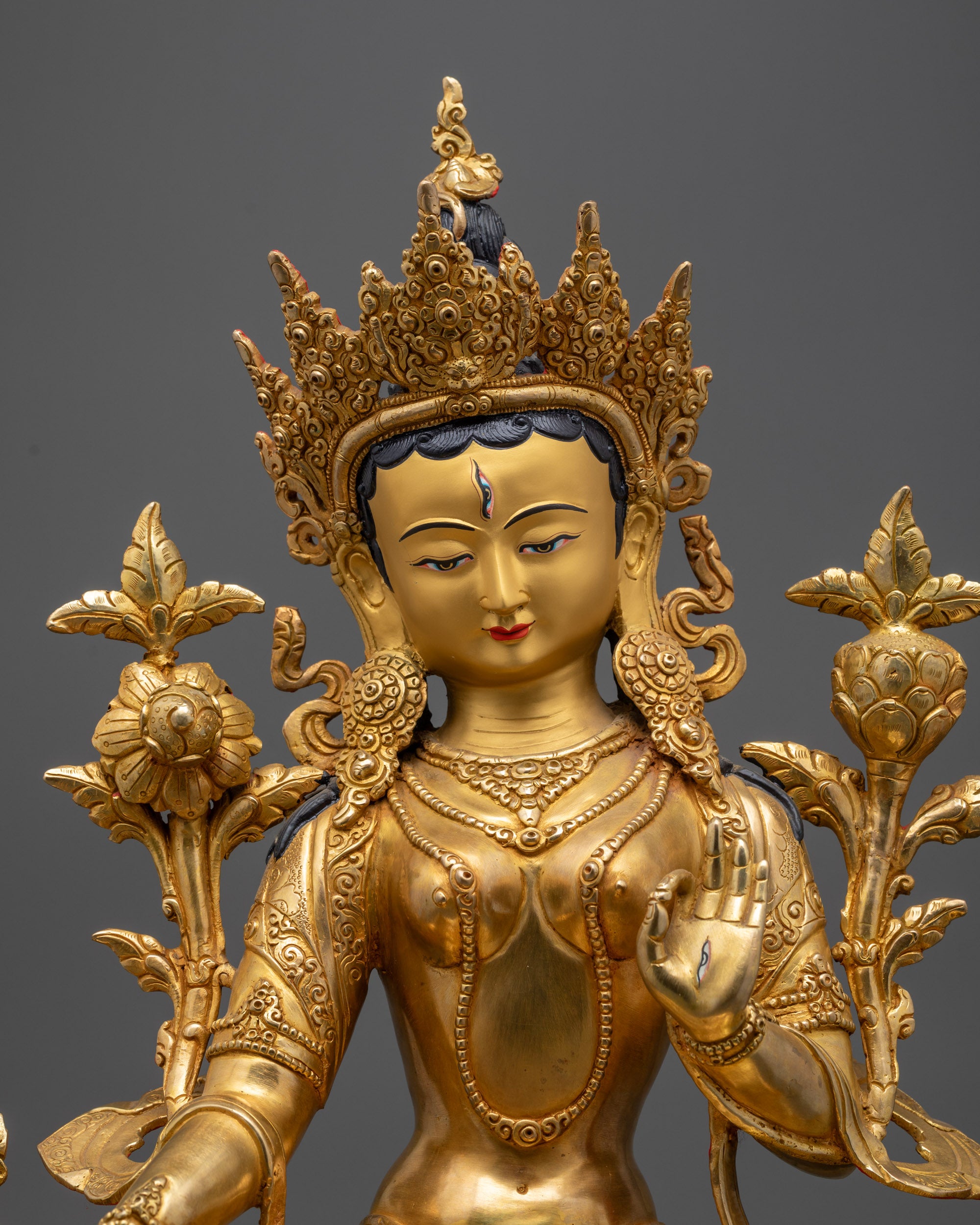 Regular close up of White Tara face with eyes, jewelry, and meditative gaze