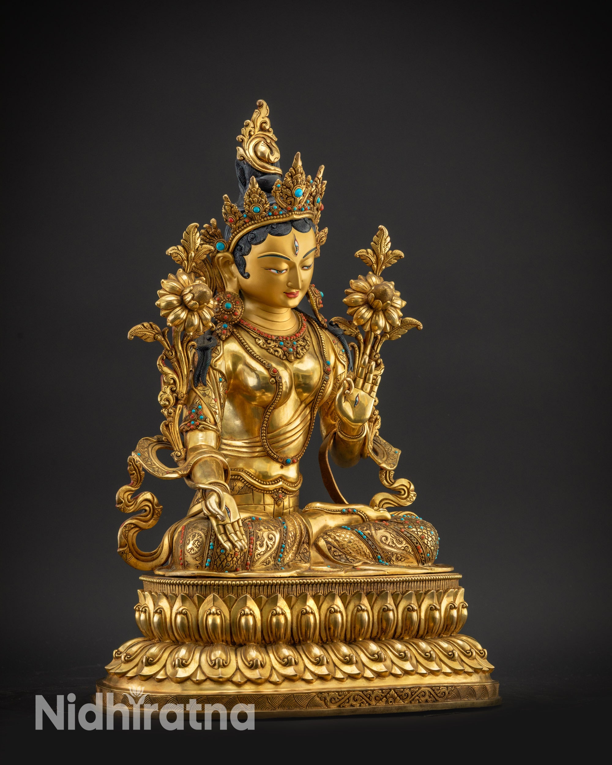 Regular right side view White Tara sculpture holding utpala flower seated lotus base