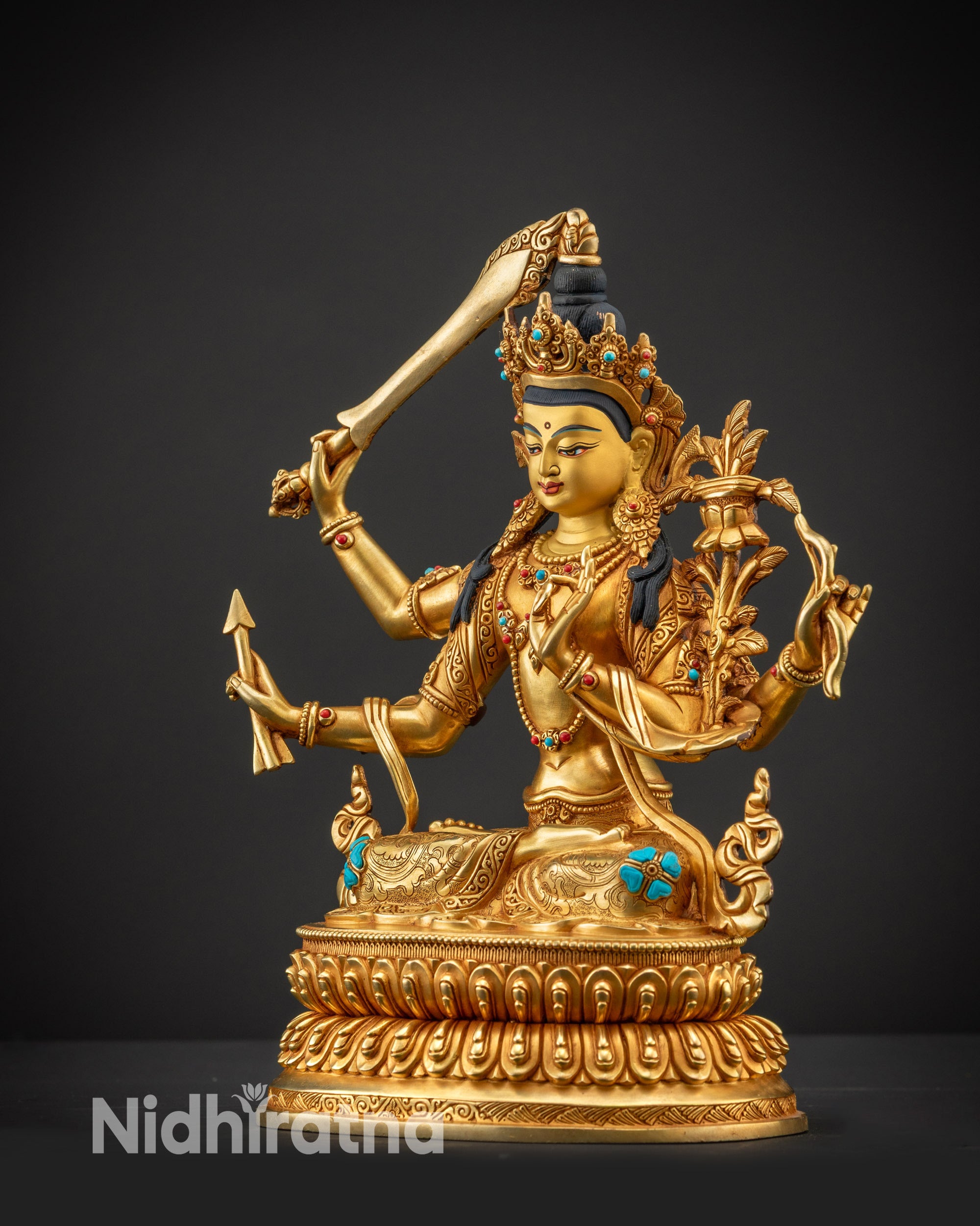 Regular side left view of Maha Manjushri statue highlighting utpala flower and bow and arrow