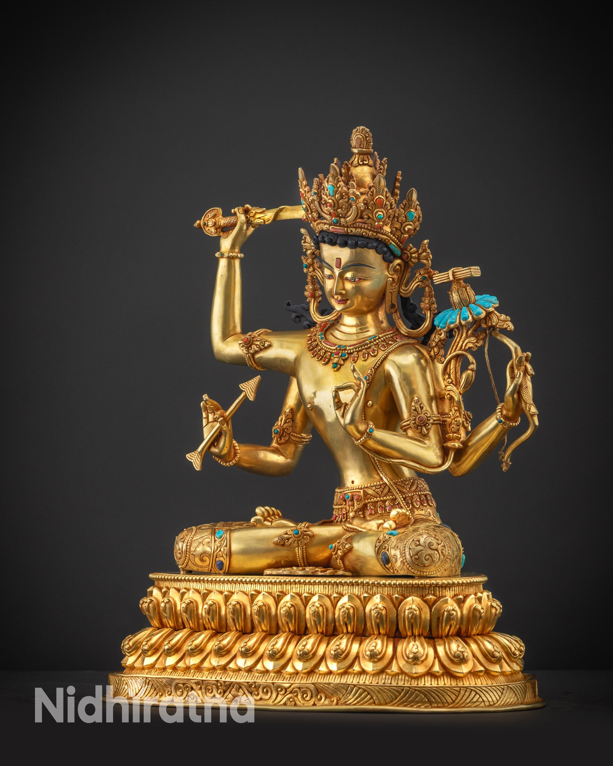 Regular side left view of Maha Manjushri statue showing utpala flower and Prajnaparamita Sutra.